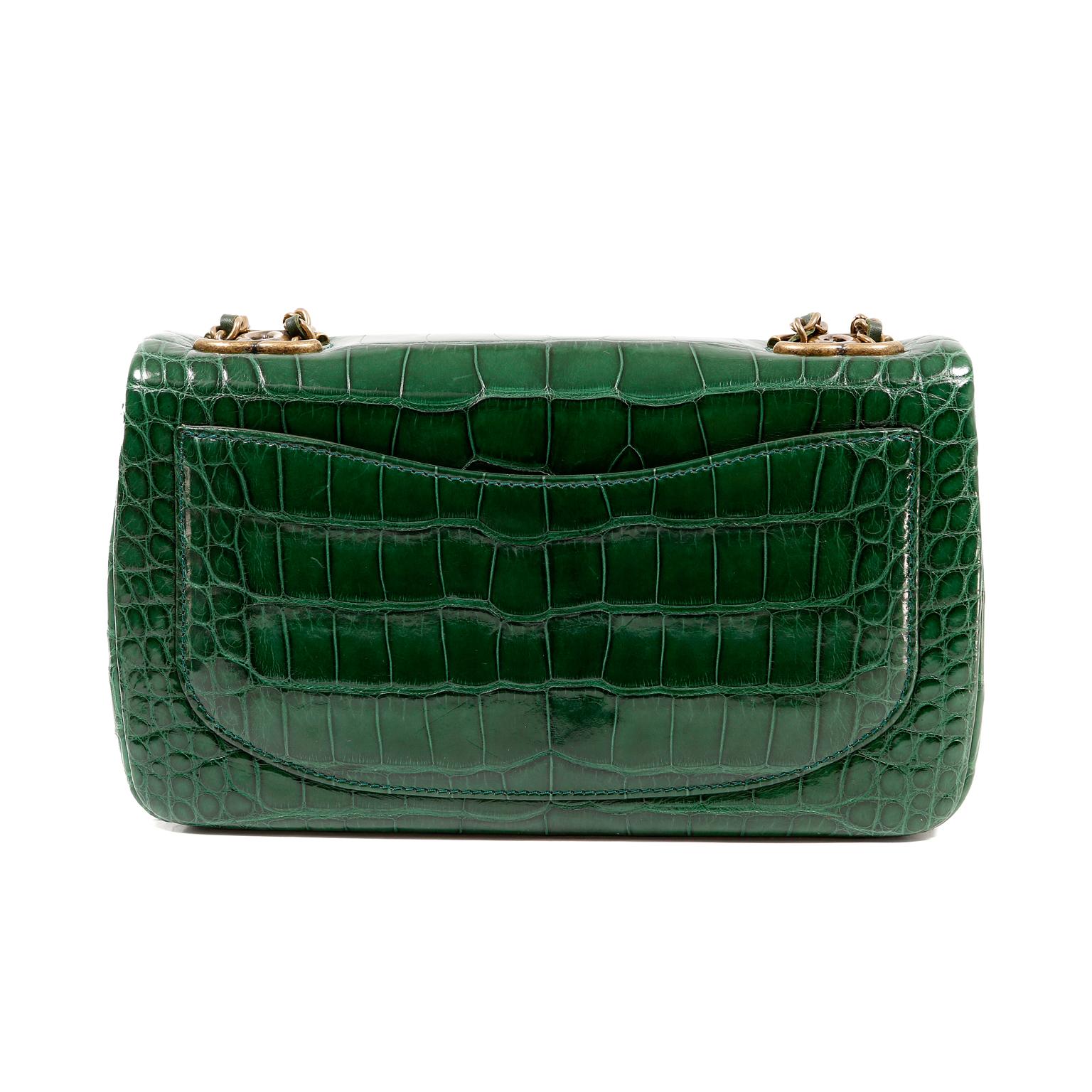 This authentic Chanel Emerald Green Alligator Medium Classic is in pristine condition.  The Timeless Classic is elevated to new heights in this rare exotic version.
Deep emerald green alligator skin is accented with antiqued gold interlocking CC