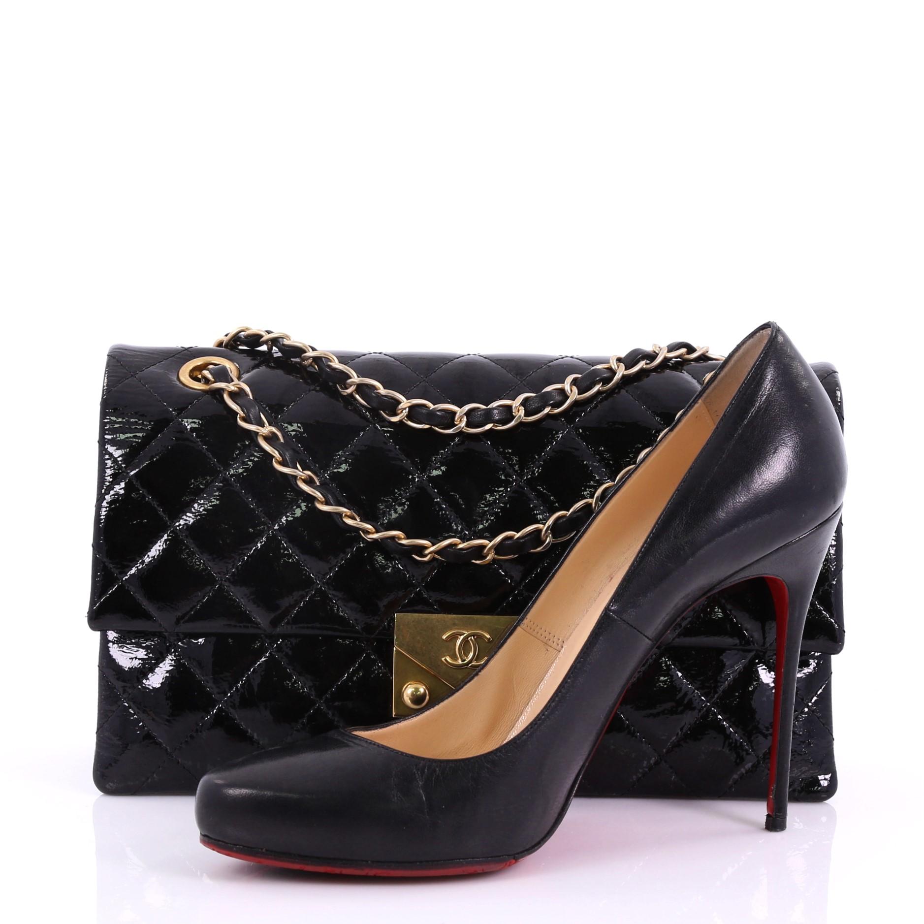 This Chanel Envelope Lock 3 Bag Quilted Goatskin Patent Small, crafted in black quilted goatskin patent, features woven-in leather chain straps and gold-tone hardware. Its push-lock closure opens to a black fabric interior divided into three