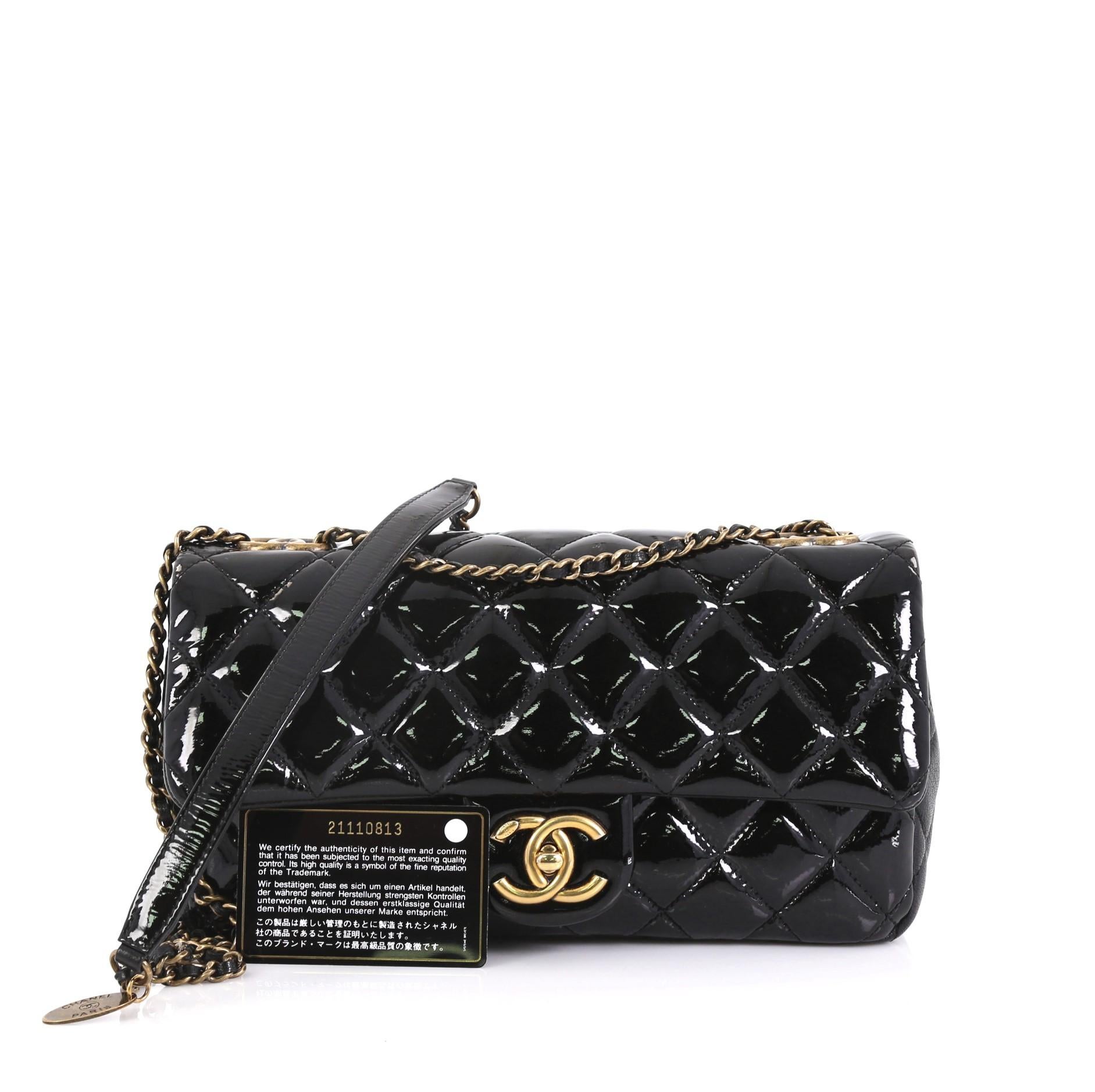 This Chanel Eyelet Flap Bag Quilted Patent Medium, crafted in black quilted patent leather and black leather, features woven-in leather chain strap with shoulder pad, exterior back pocket, and aged gold-tone hardware. Its CC turn-lock closure opens