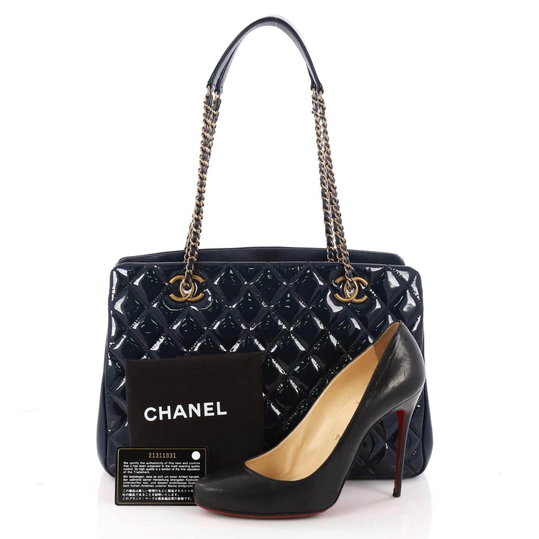 This authentic Chanel Eyelet Tote Quilted Patent Medium is an excellent bag for day or evening wear. Crafted in blue quilted patent leather, this bag features woven-in leather chain straps with leather pads, CC logo on eyelets, two exterior side
