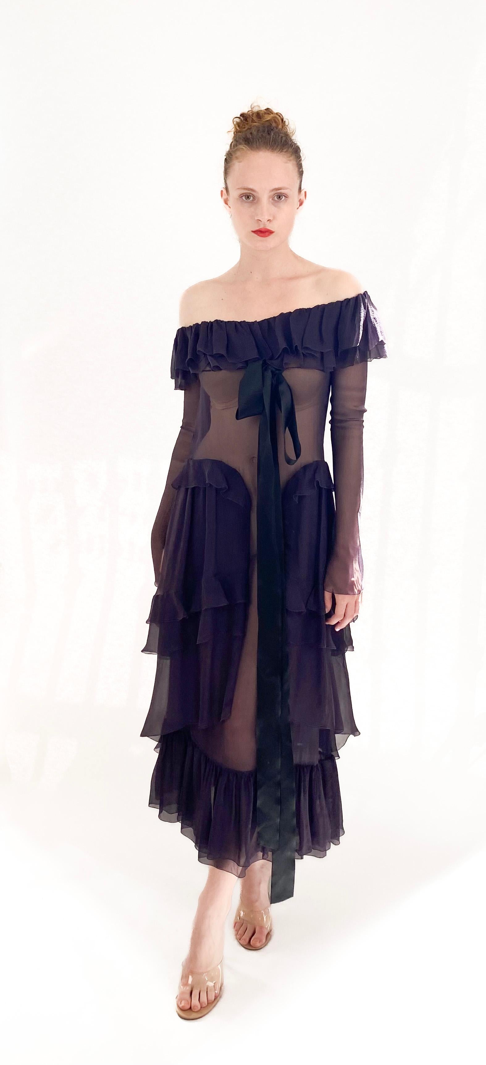 Stun the fashion world with this sheer, silk Chanel F/W 2003 dress. A runway exclusive, it boasts an elegant off-the-shoulder ruffle design and a dropped waist silhouette. The delicate fabric and replaced button add to its unique charm.

Notes: We