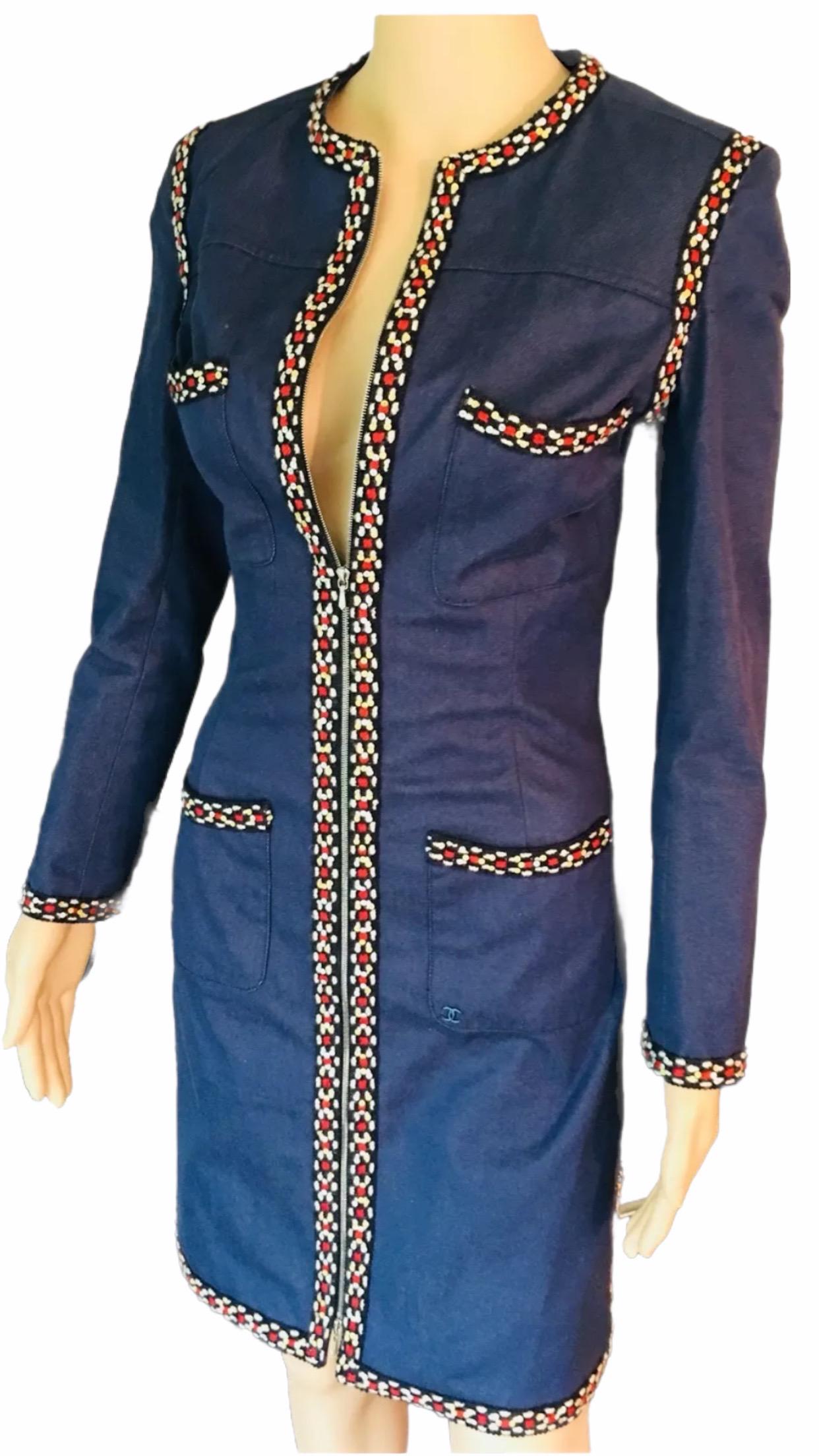 Chanel denim knee-length coat with sequin embellished trim, structured shoulders, long sleeves, four patch pockets featuring interlocking CC adornment and exposed zip closure at front. From the Fall 2004 Collection. Very versatile piece could be