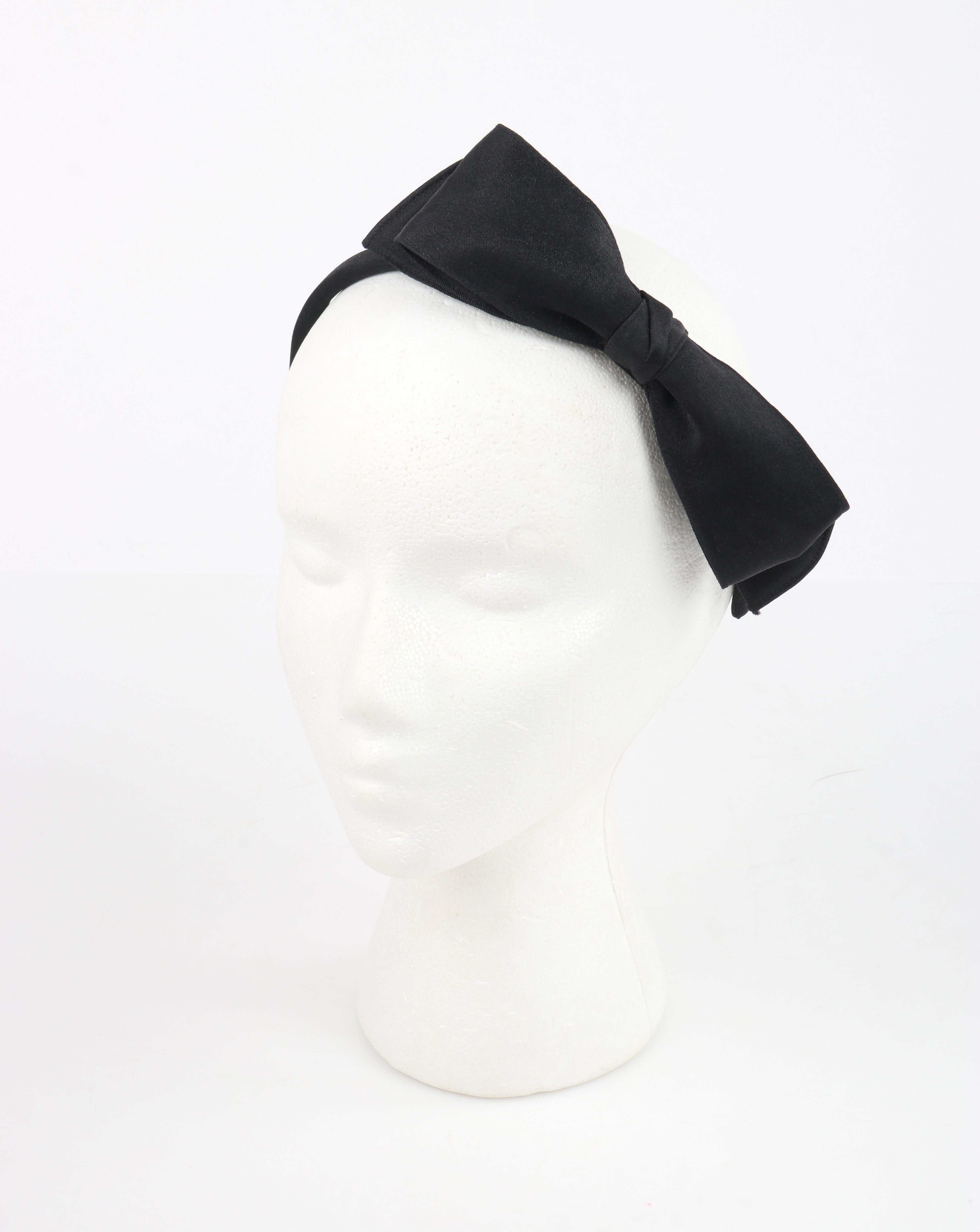 CHANEL F/W 2006 Black Satin Large Asymmetrical Classic Bow Headband Headpiece

Brand / Manufacturer: Chanel
Collection: F/W 2006
Designer: Karl Lagerfeld
Style: Headband
Color(s): Black
Lined: No
Unmarked Fabric (feel of): Satin
Additional Details /