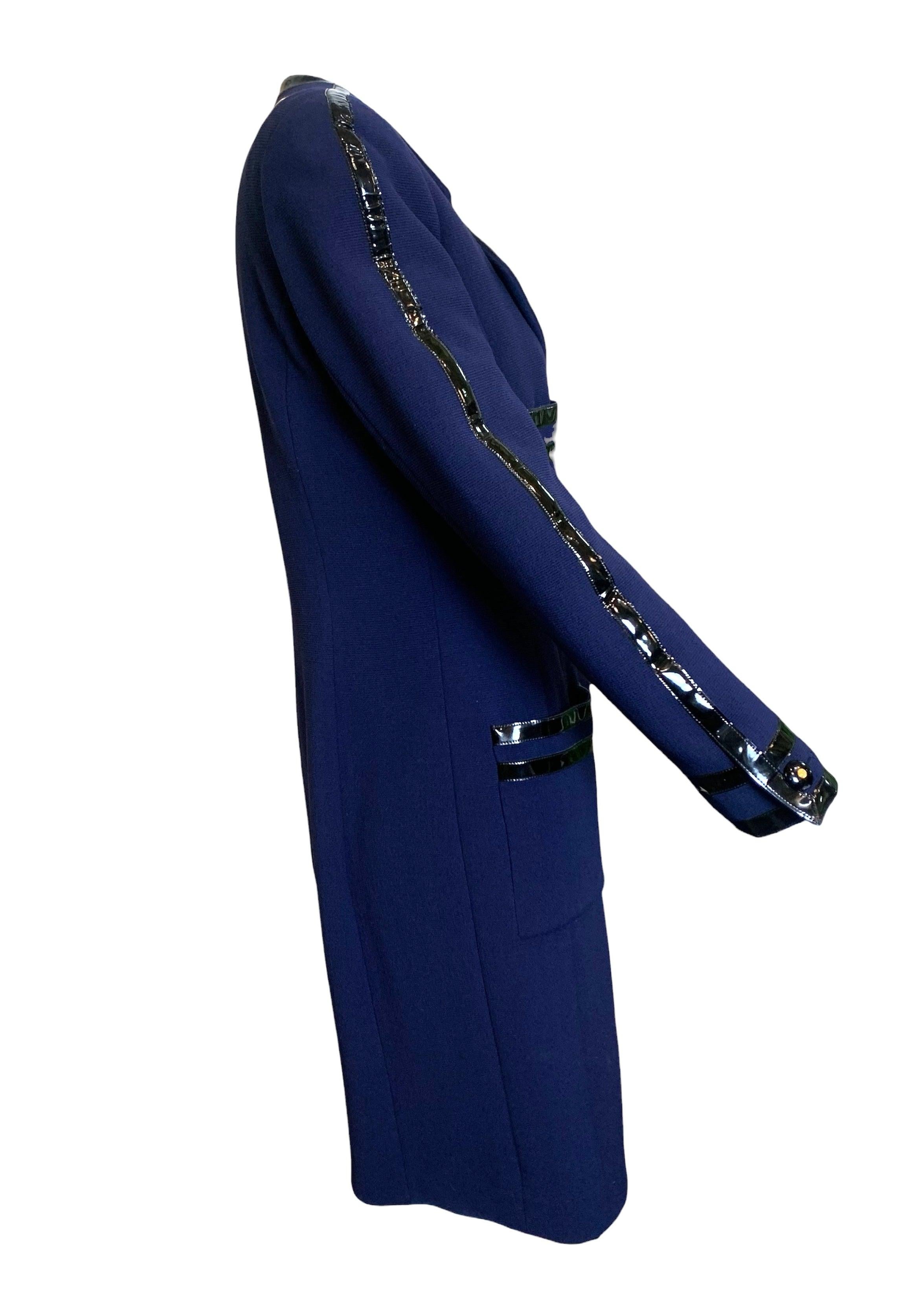 Iconic Chanel Fall/Winter 1991/1992 navy blue coat dress. As seen on the Haute Couture runway on Christy Turlington in a slightly different iteration. Ribbed wool trimmed with black patent leather. The fully lined dress features a peaked collar,
