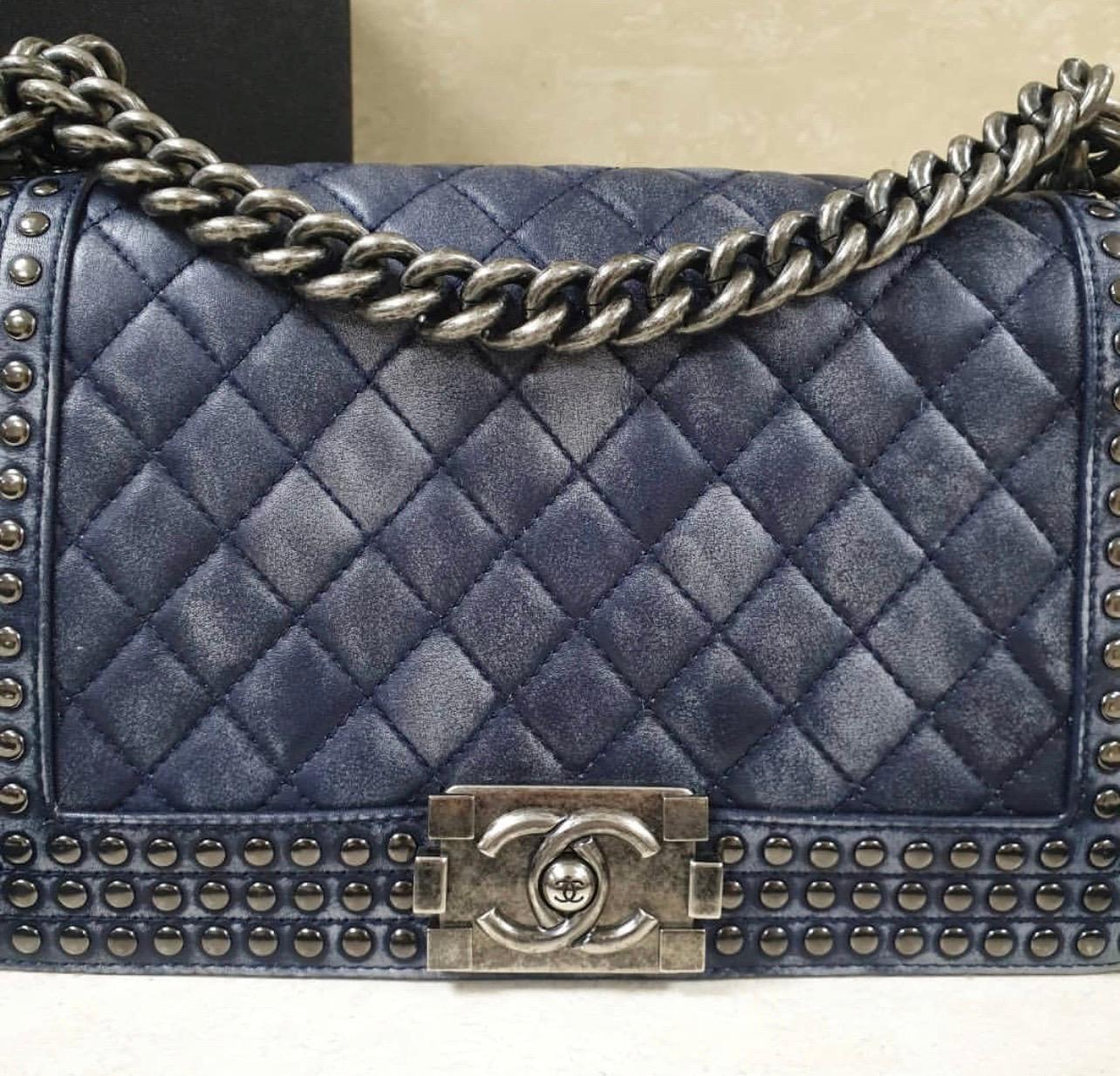Chanel Medium Boy Faded Leather Studded Flap Bag from Chanel Paris-Dallas 2014 collection has been hand-finished by skilled artisans in the label's workshop.
Boasting soft faded blue quilted lambskin-leather exterior and studded detail along the