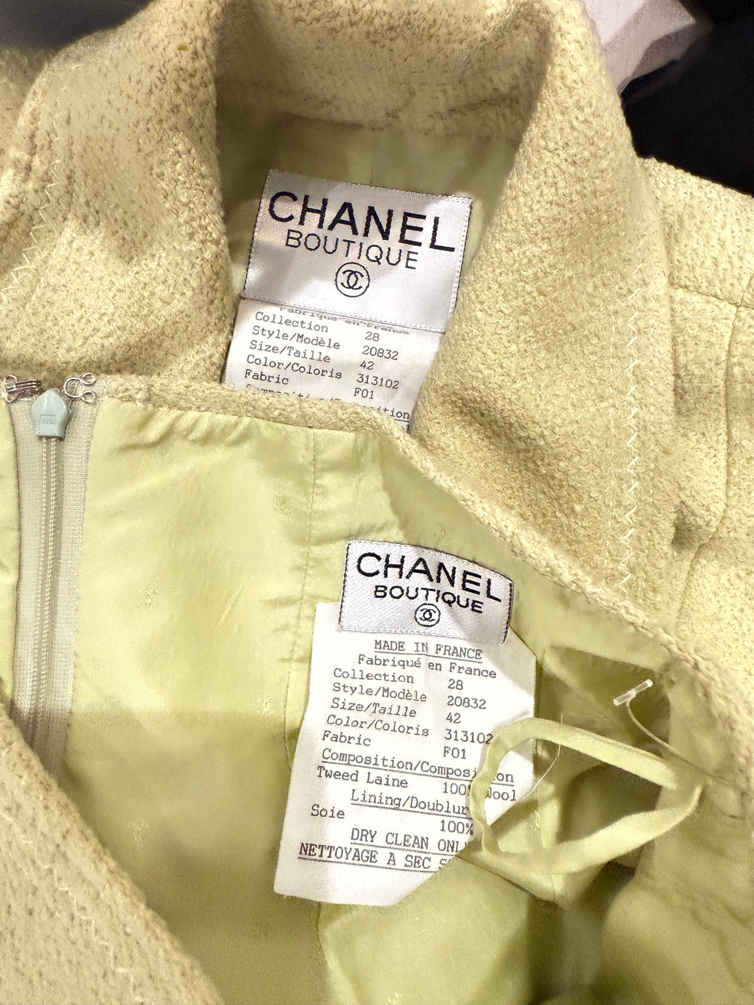 Chic and iconic Chanel Fall / Winter 1991 lime green belted skirt suit ! Deigned by Karl Lagerfeld. Signature soft tweed wool with silk lining. Lining features the CC logo throughout and the signature weighted gold chain along the inner hem. Pockets