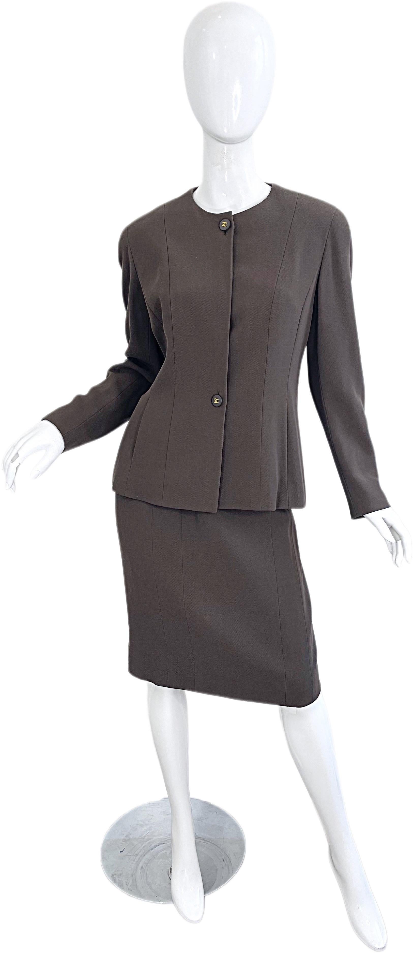 Vintage Chanel Fall 1994 army/military green lightweight wool skirt suit ! Designed by Karl Lagerfeld. Features a tailored jacket with buttons one large button with CC logo at center neck and at waist. Hidden buttons in between. Five logo embossed