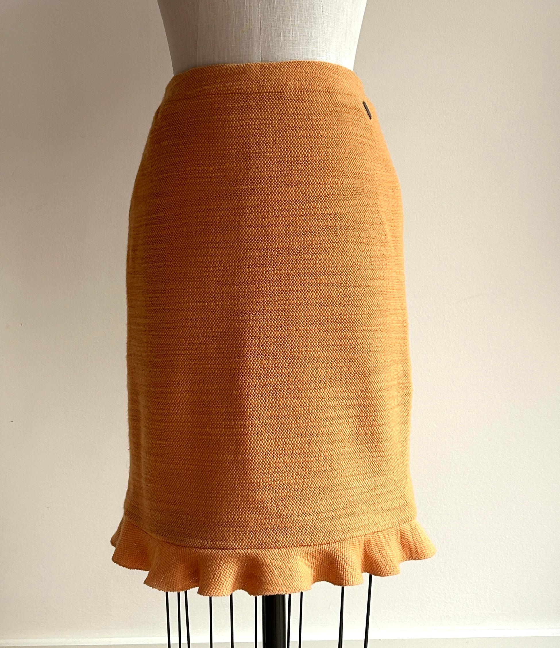 Vintage Chanel 1990s orange tweed pencil skirt with ruffle hem. Soft, textured wool in a sunshiny orange. Logo plaque reads 