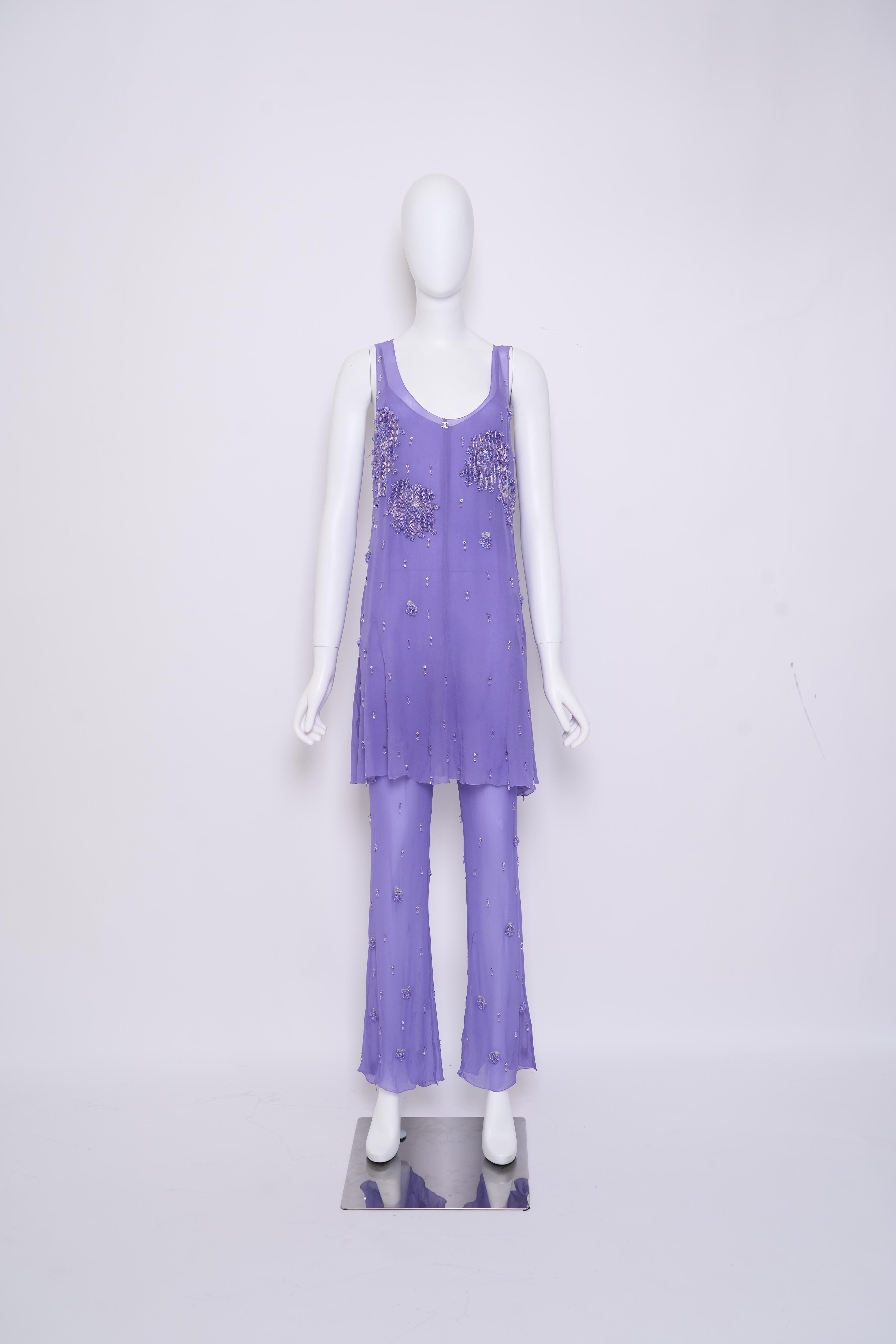 

Exuding elegance, this Chanel 2000 Fall Demi-Couture ensemble features a flowing purple shiffon top with delicate embellishments, paired with coordinating shiffon pants. The soft, vibrant purple hue and flowy silhouette create a striking, feminine