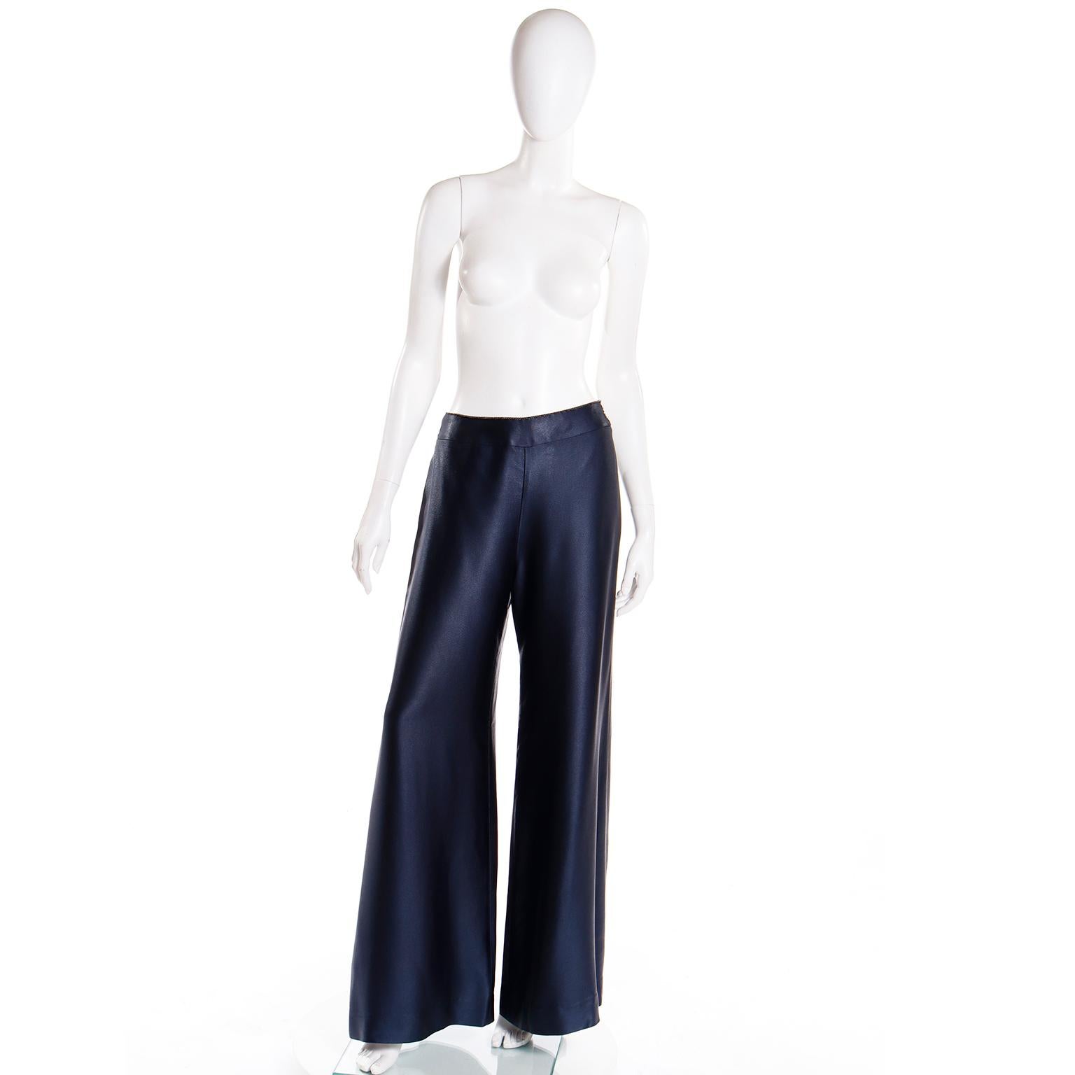 These luxe Fall 2000 Chanel vintage trousers are in a midnight blue rayon with a luxe satin finish. The pants have wide straight legs and are fully lined. There is a plastic CC stitched at the left hip and the pants close with a hidden zipper and