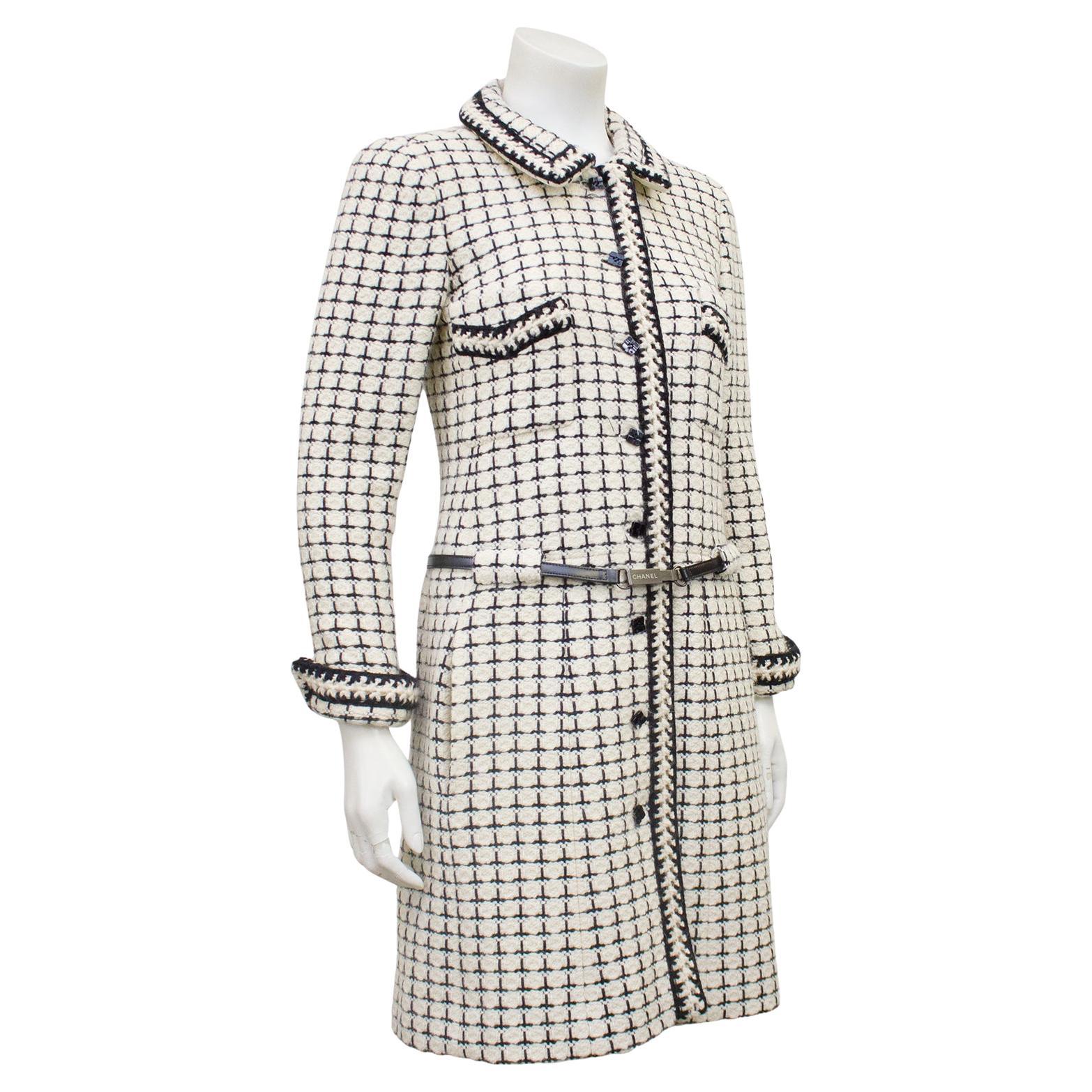 Stunning and classic Chanel long white and black boucle jacket from the Fall 2000 collection. Rolled collar and cuffs. Thick white with black trim at collar, cuffs, pockets and down centre. Patch pockets at bust and vertical slit pockets at hips.