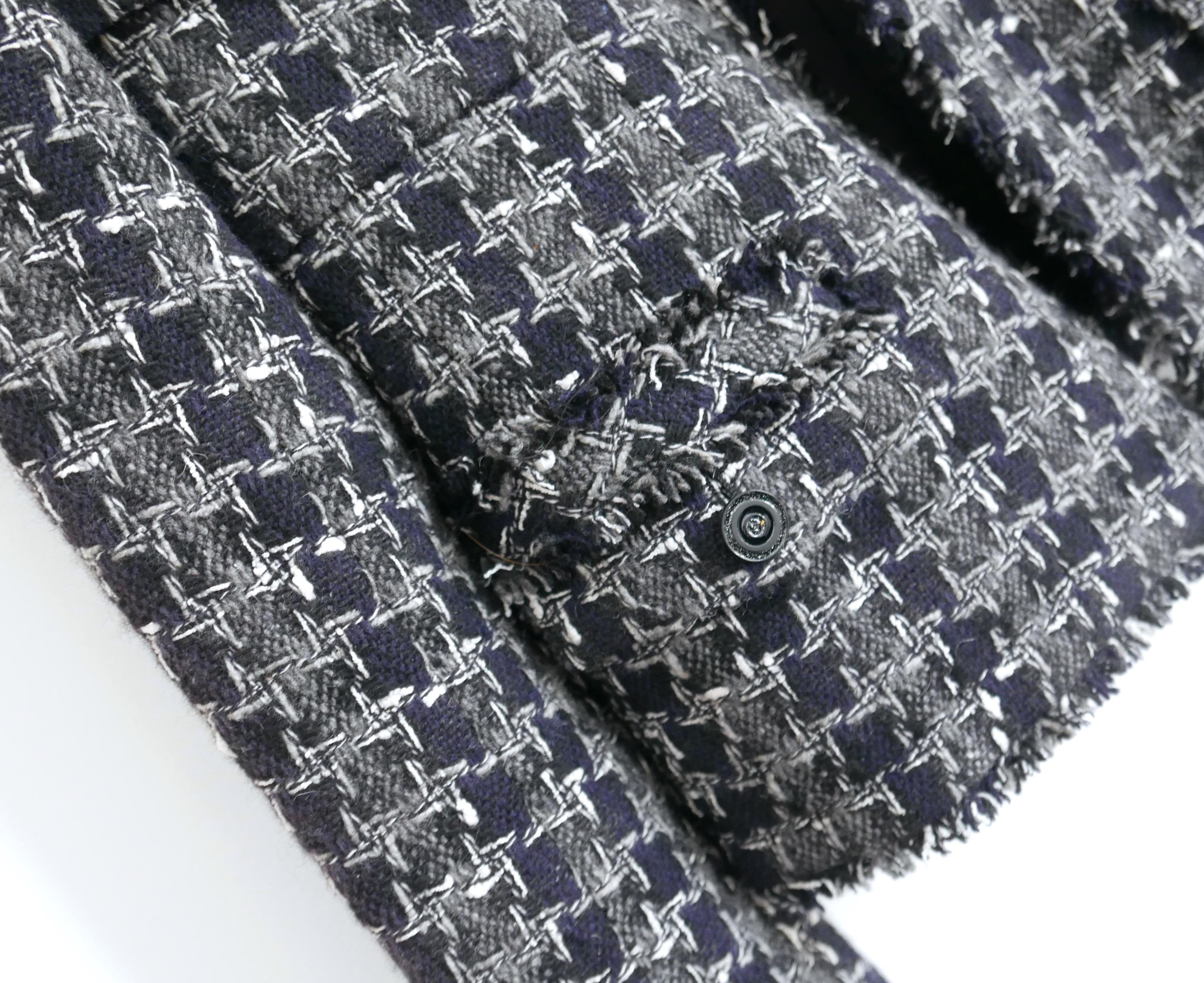 Stunning Chanel houndstooth tweed jacket from the Fall 2007 07A - collection. Worn once and comes with spare button/fabric swatch. 
Made from super soft 90% cashmere navy and grey check tweed with raw edged detailing. It has a semi tailored, open