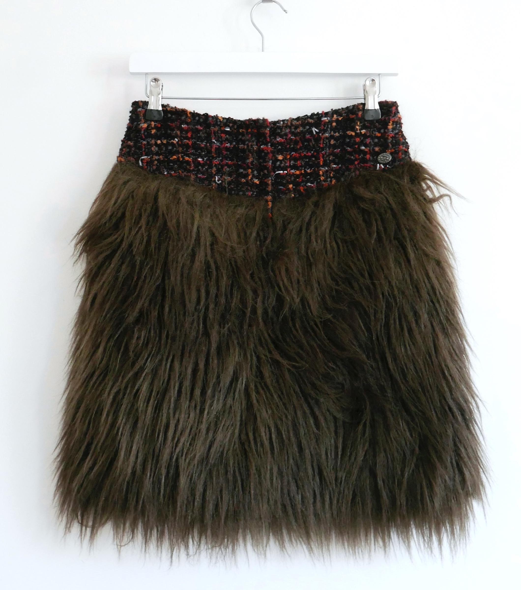 Iconic Chanel skirt from the legendary Fall 2010 collection. Unworn. Look 17 on the runway. A true collectors' piece. Made from wool mix, fantasy tweed and lush faux fur, it has zip fly to front, little CC badge to hip and black silk lining. Size