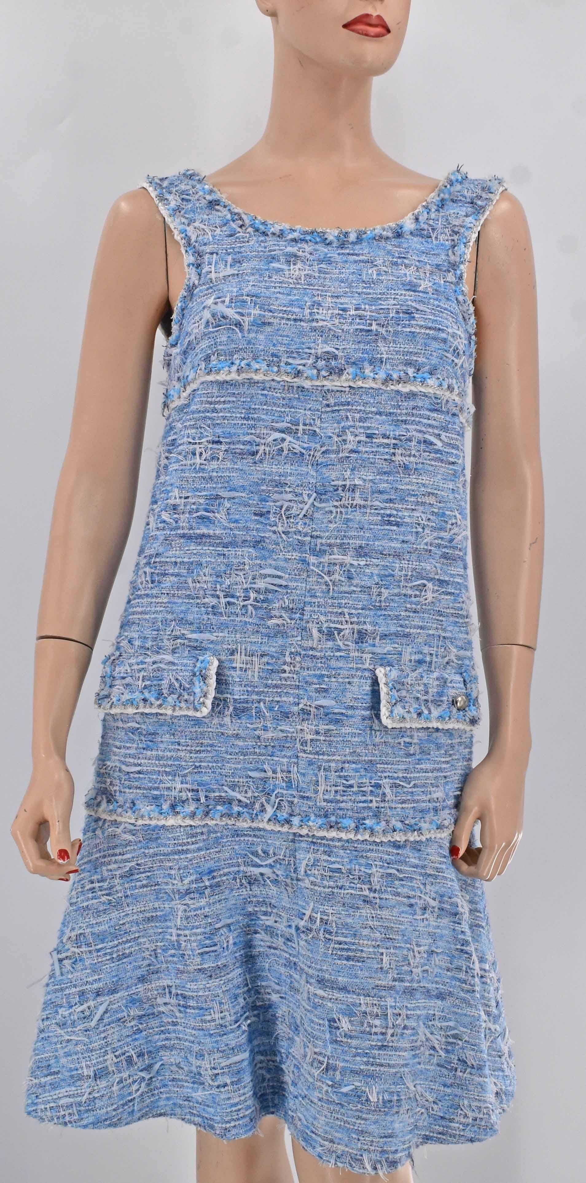 Chanel fantasy tweed dress with Chanel interlocking CC logo emblem. Color is beautiful blend of light blue and white. It retails $6200 before tax. 
