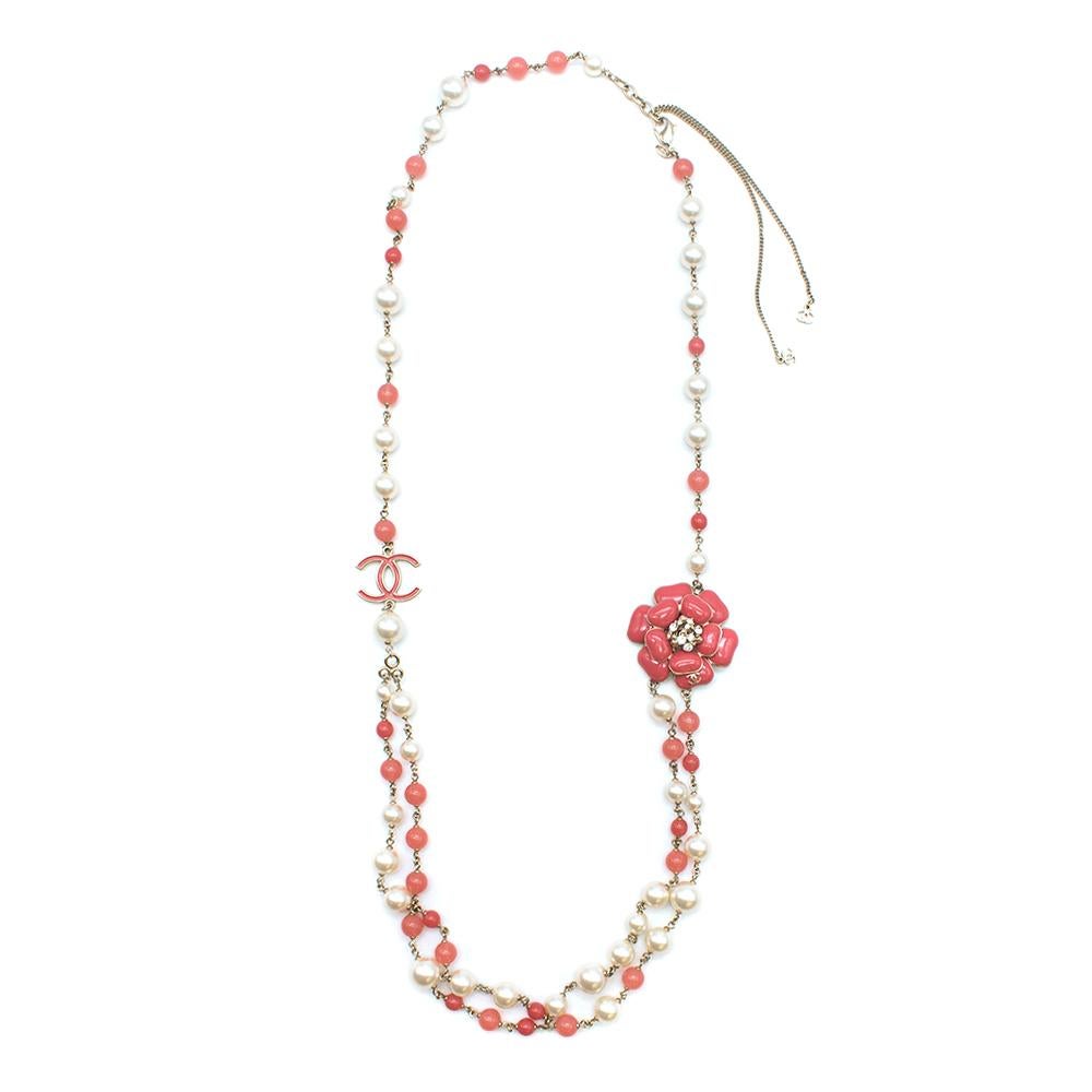 Chanel Faux Pearl and Crystal CC Camellia Necklace 

-Single Strand with small and large faux  pearls and coral beads leading into a double strand at the bottom
-Large coral crystal embellished camellia pendant
- Coral CC Pendant
-Ivory, Coral and
