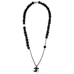 CHANEL Faux Pearl 
Black Bead CC Pendant Necklace