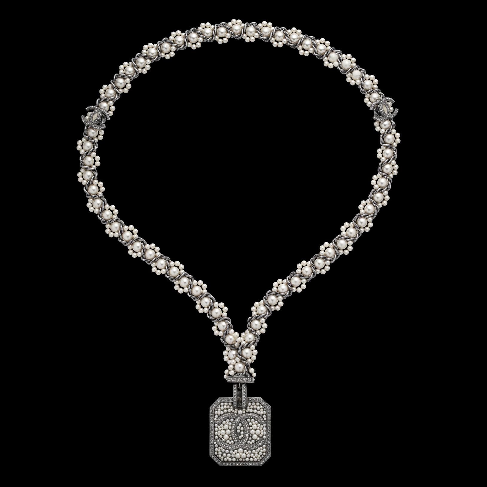 An elegant statement piece! The pendant features the icon interlocking CC logo, adorned with strass crystals and faux pearls, to a woven chain. It blends classic Chanel glamour with modern sophistication. The necklace is marked for 2017 High Summer