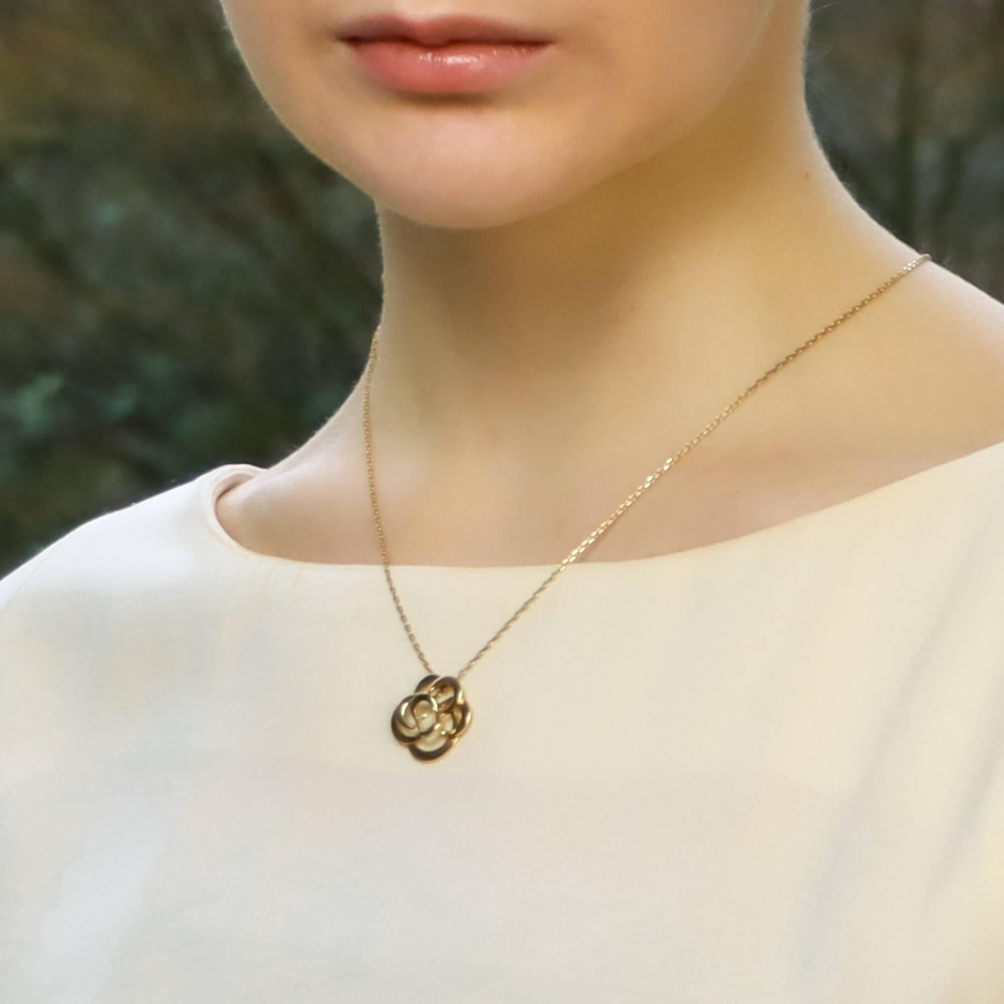 A beautiful CHANEL Fil De Camélia Flower Pendant Necklace set is 18k yellow gold.

The pendant depicts the signature CHANEL Camélia flower on a 22 inch yellow gold chain. The beauty of this piece lines in the design, the polished yellow gold makes