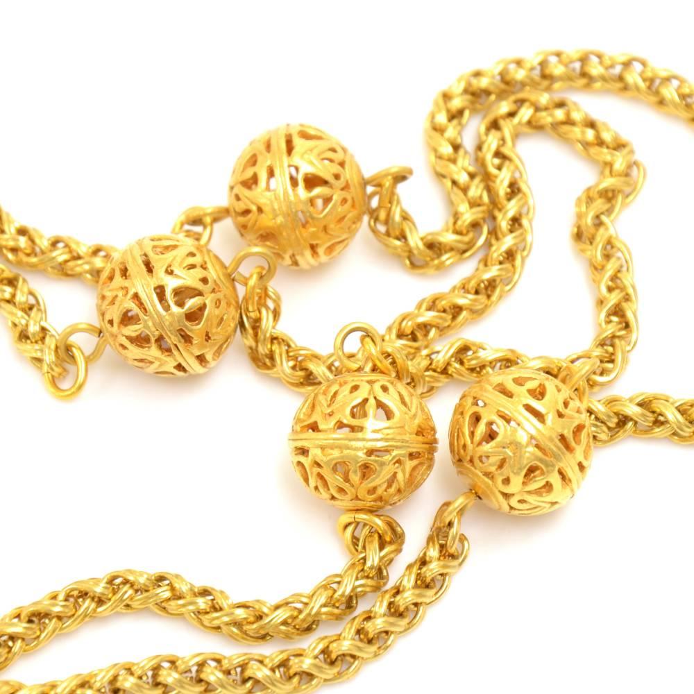 Chanel gold-tone chain necklace. Has 4 filigree ball pendants and a hook closure.