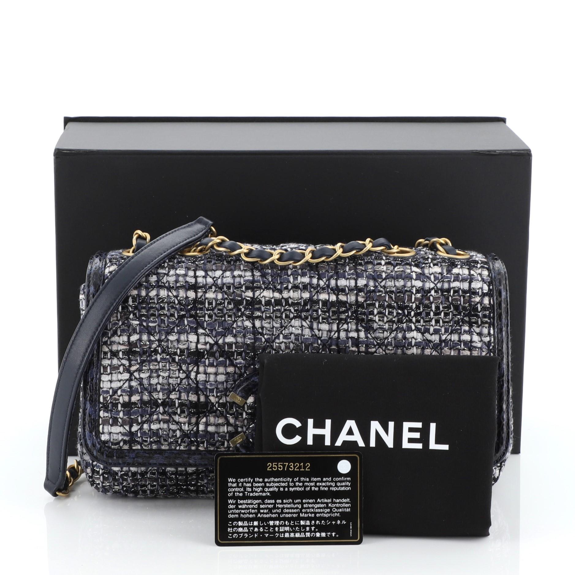 This Chanel Filigree Flap Bag Quilted Tweed with Watersnake Medium, crafted in blue quilted tweed with genuine watersnake, features woven-in leather chain strap, interlocking CC logo stitched on front, exterior back slip pocket and aged gold-tone