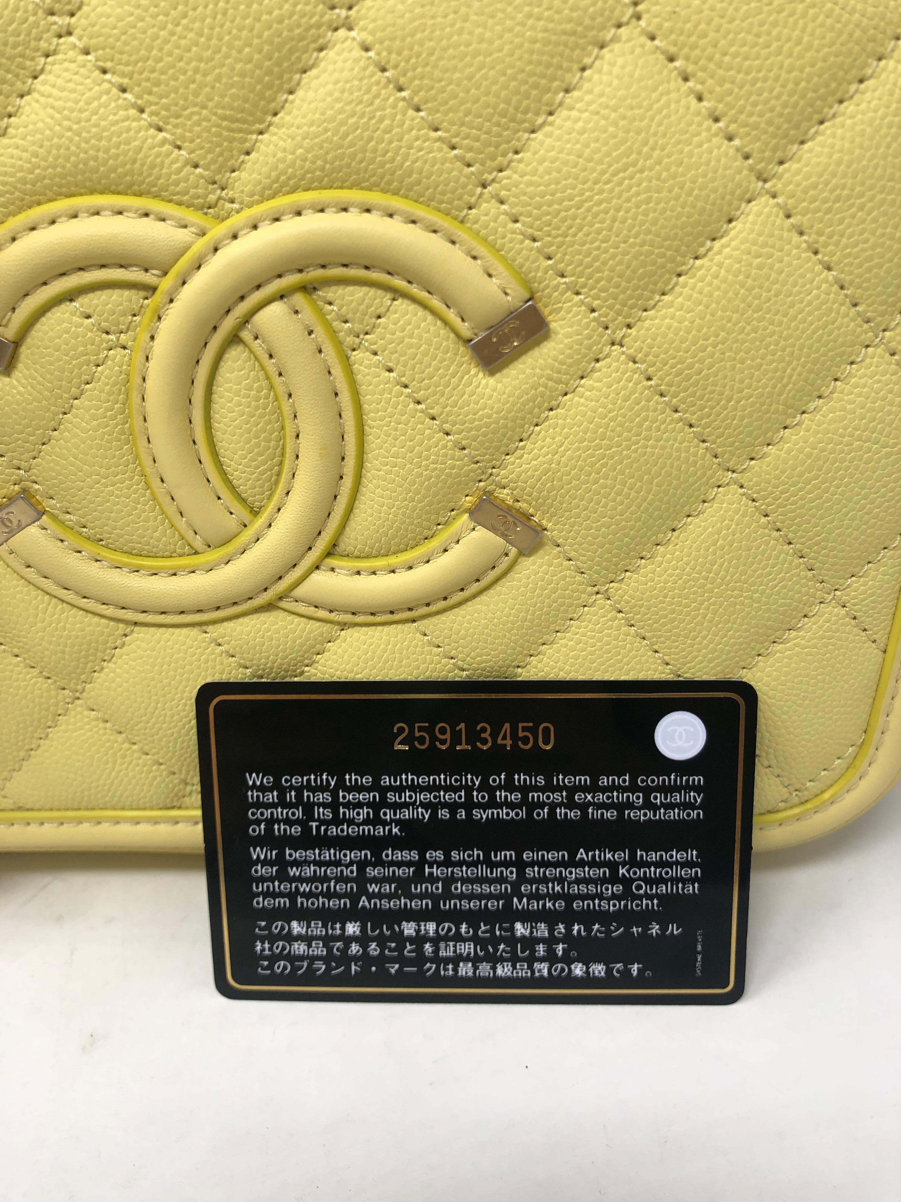Chanel Filigree Vanity Case Bag in pale yellow leather. Rare color and most wanted bag for Chanel lovers. Nice caviar leather. Never used. Brushed gold tone hardware with lock and keys. Includes authenticity card, dust cover, and original box.