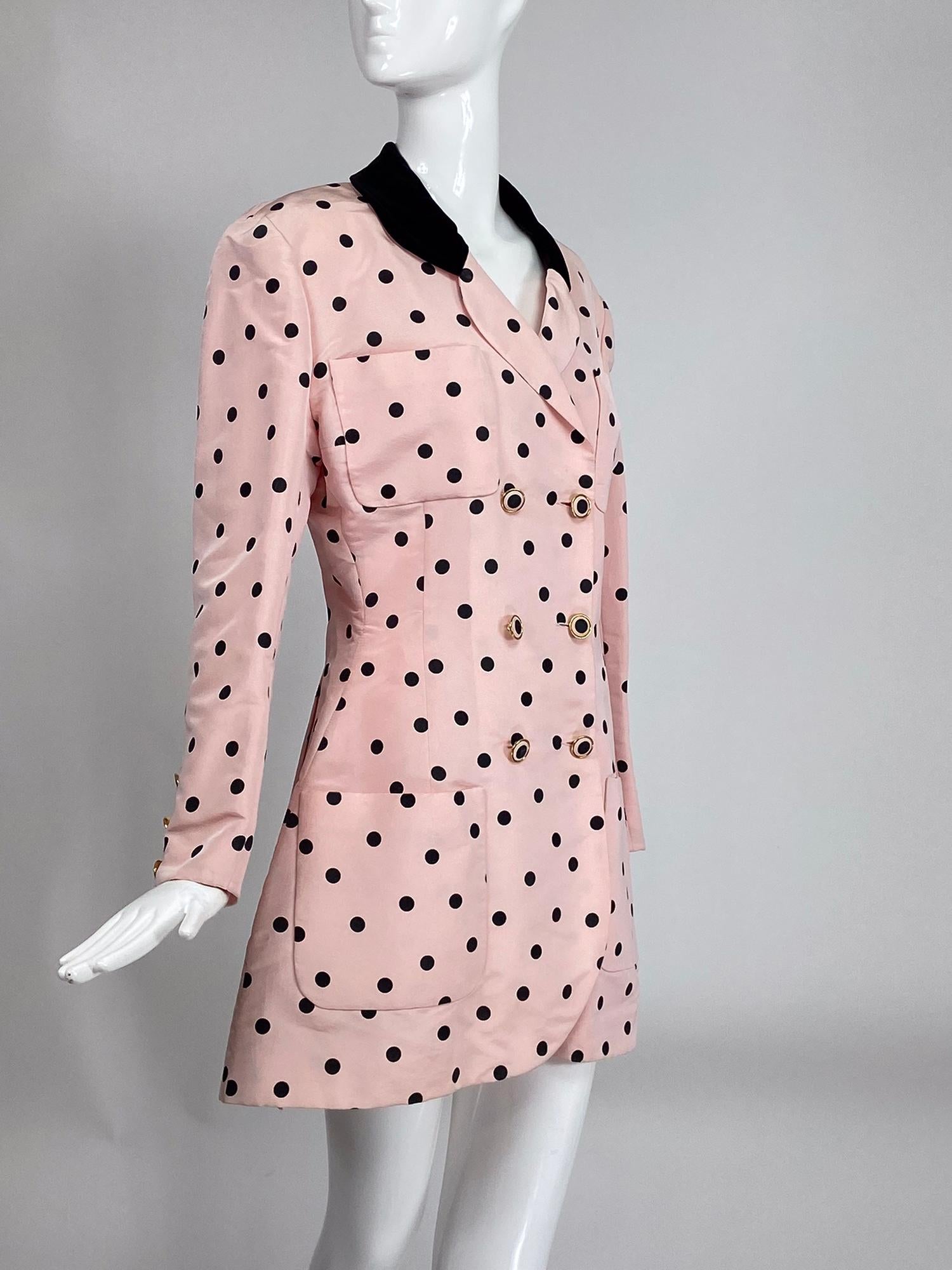 Chanel fitted silk faille pink & black dot jacket from the 1990s. Double breasted jacket is fitted through the waist and flairs at the hem. The jacket has a black velvet collar and has two open breast pockets and two open hip pockets. Long sleeves