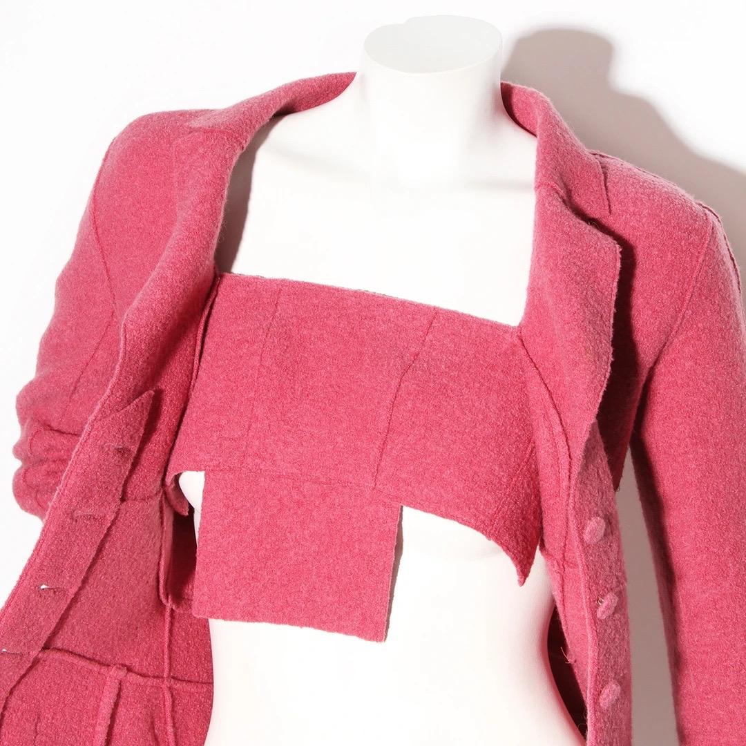 Chanel by Karl Lagerfeld 
Chanel Fall / Winter 1999 Ready to Wear Collection
Made in France 
Pink wool felt 
Notched collar
Single breasted blazer 
Four fabric covered buttons 
Seam details
Fitted waist
Detachable fabric panel in front bust of