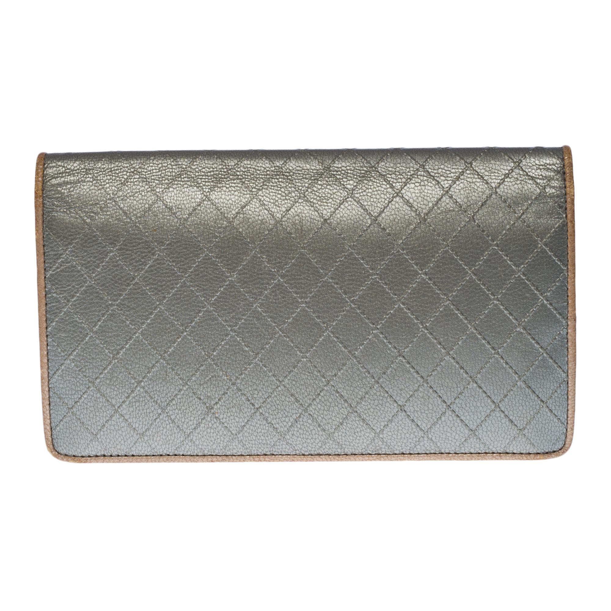 Charming Chanel Wallet in Metallic Silver leather Flap and Silver Metal Flap
Gold-tone lambskin interior with storage compartment for 8 credit cards, 5 patch pockets, 1 coin zipped compartment
Inside logo and border piping in gold leather
Signature: