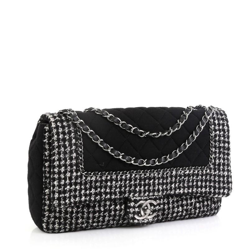 This Chanel Flap with Chain Bag Quilted Tweed and Jersey Jumbo, crafted in black quilted tweed and jersey, features woven-in leather chain strap, woven-in chain link trims and gunmetal-tone hardware. Its push-lock closure opens to a black leather