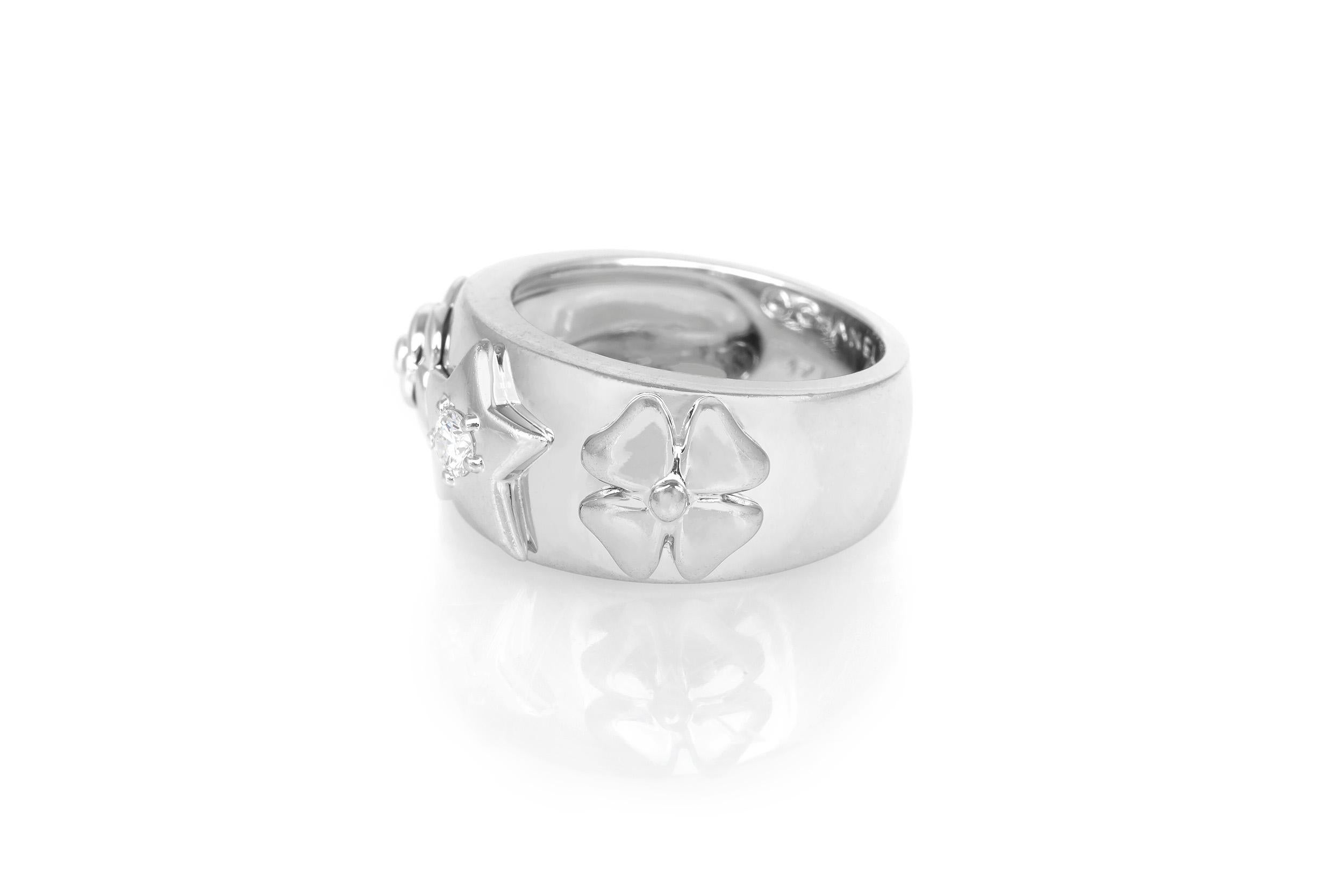 This vintage, 18K white gold Chanel ring features an embossed floral motif and a diamond-stud detail.
Ring size 5.5.