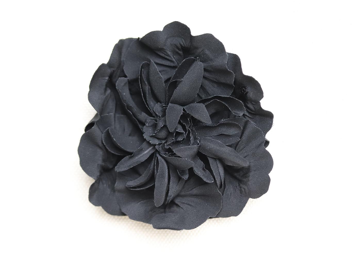 Chanel's pretty brooch is adorned with incredibly lifelike structured silk-chiffon floral petals ranging in different sizes, fastened onto a silver pin, it will make an elegant adornment to blazer lapels or at the neck of a pussy-bow blouse.
Black