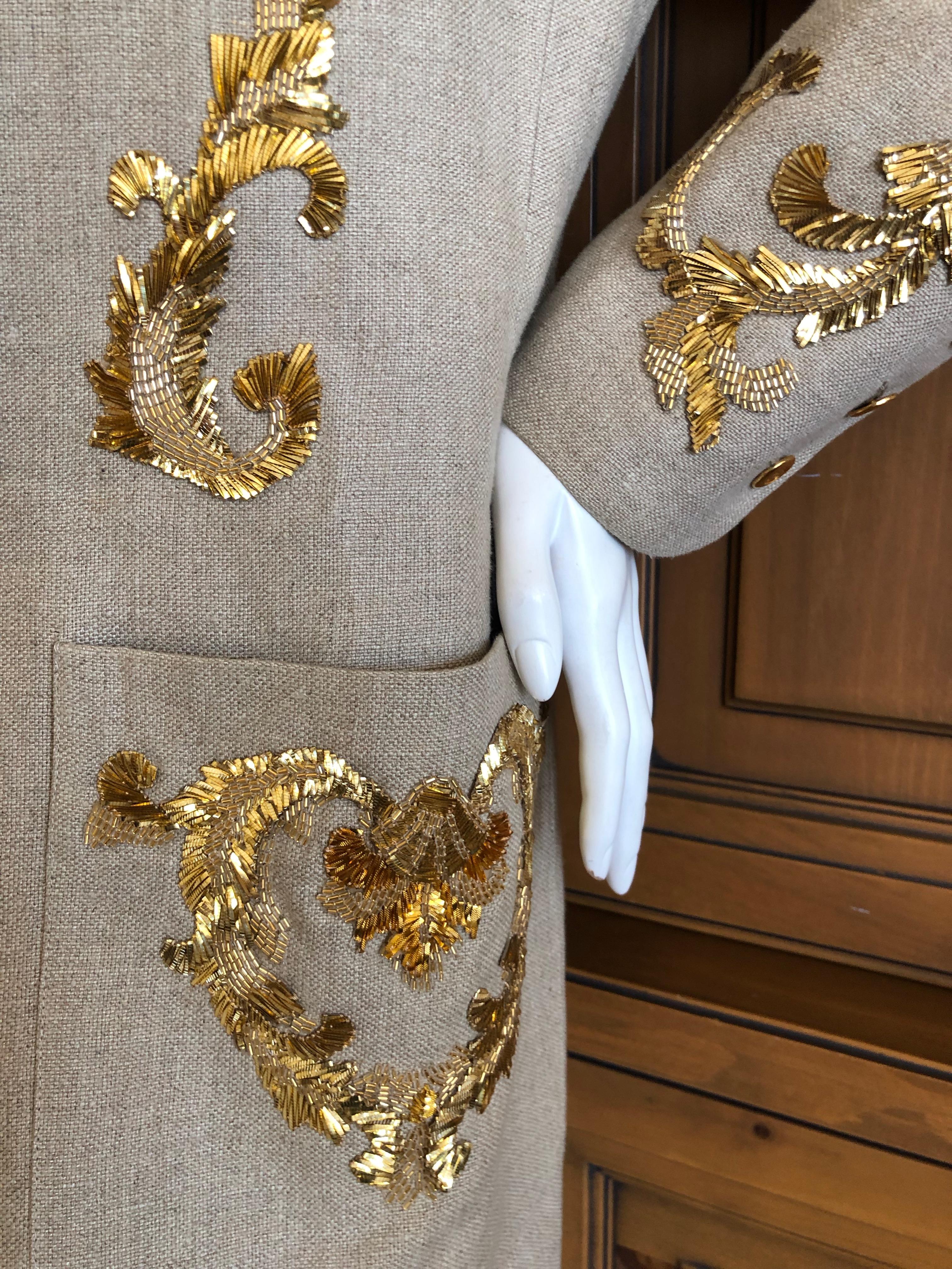 Chanel Embellished Linen Jacket.
The ornamentation is an exquisite example of gold ribbon work and beading by the house of Lesage.
Scrollwork motif on the top, heart shaped on each pocket. Sleeves also have small scroll beadwork.
There is no size