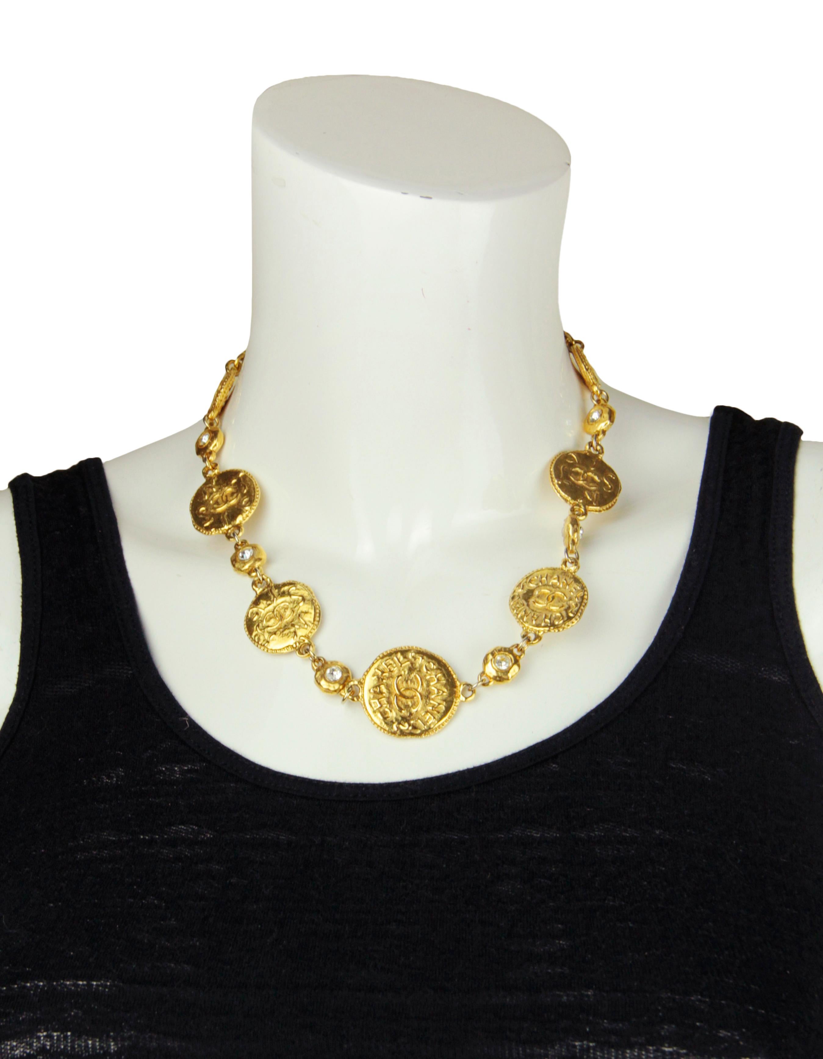 Chanel 80s/90s Vintage Goldtone Coin Choker Necklace w. Crystals. Features CHANEL CC coin stations in varying sizes with crystals. 
Made In: France
Year of Production: 1980s/90s
Color: Goldtone
Materials: Metal
Hallmarks: CHANEL MADE IN