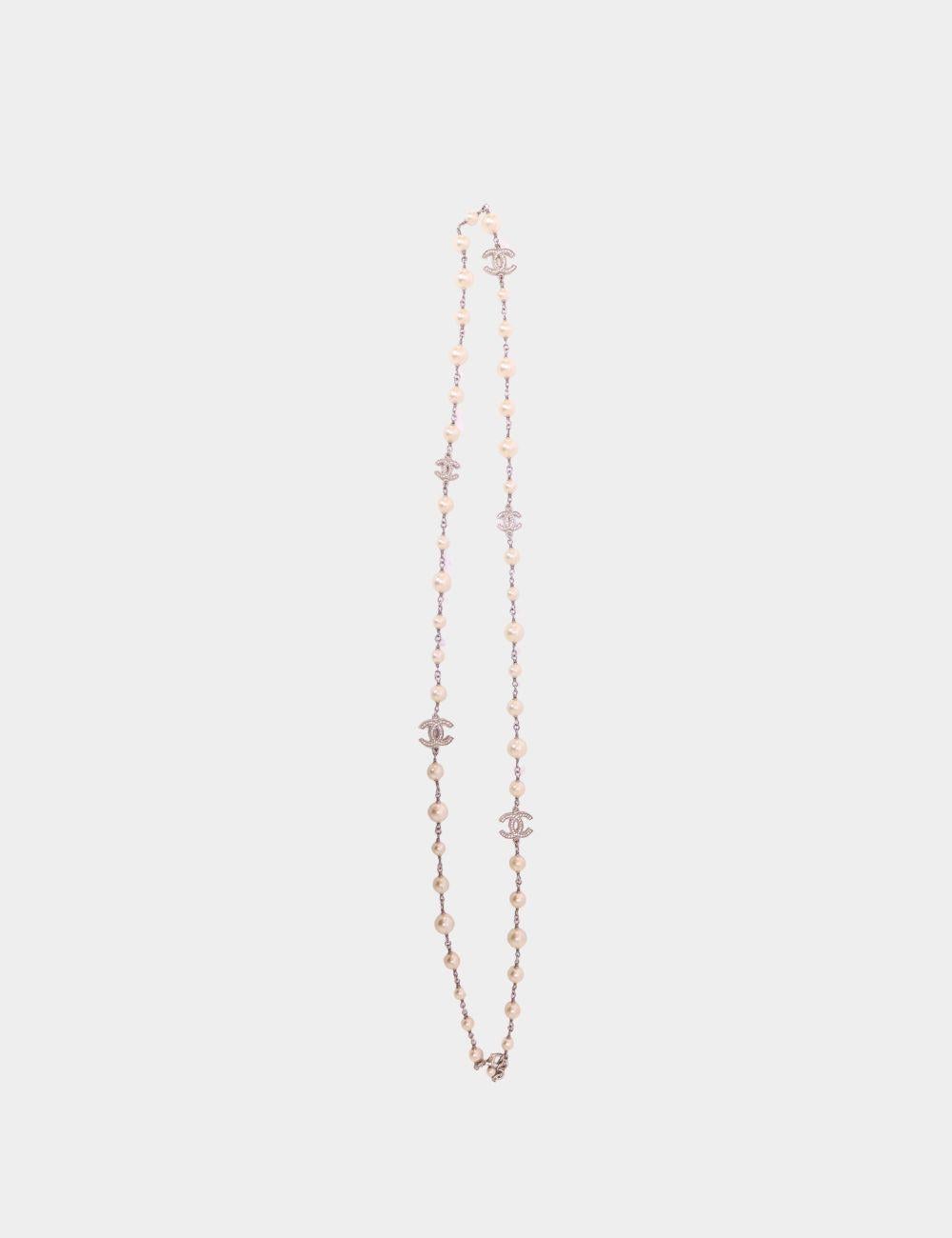 Elevate your jewelry collection with this authentic Chanel Vintage Pearl & Crystal CC Logo Necklace. Exuding classic Parisian elegance, this statement piece features lustrous faux pearls beautifully interlaced with shimmering crystal-embellished CC