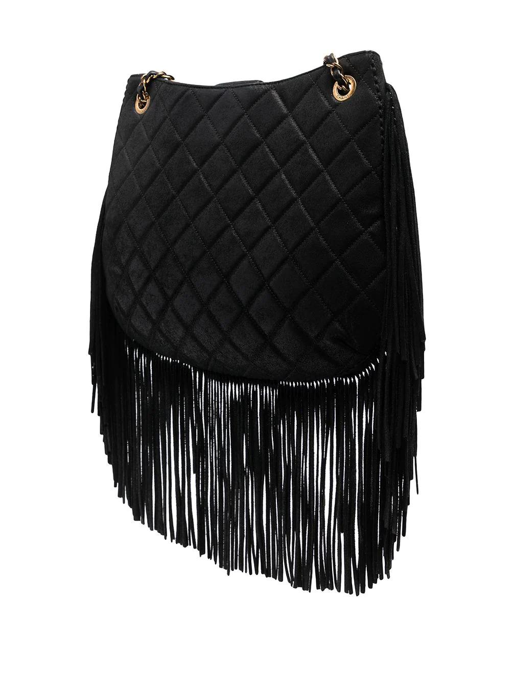The bag selection from the 2014 Paris-Dallas Collection featured a number designs with references to horse satchels, riding gear and tassels. This pre-owned Chanel bag is no different, with hobo style fringe attached to the bottom for a western