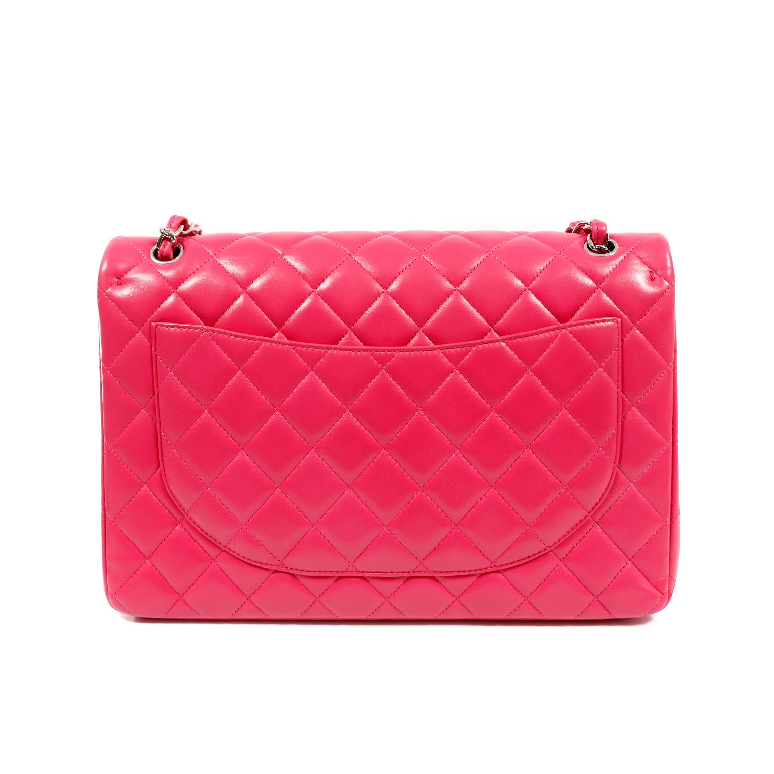 This authentic Chanel Fuchsia Lambskin Maxi Classic Flap is in pristine condition, appearing never carried.  A truly timeless piece, the Maxi is certain to hold its value.
Vibrant fuchsia pink lambskin is quilted in signature Chanel diamond pattern.