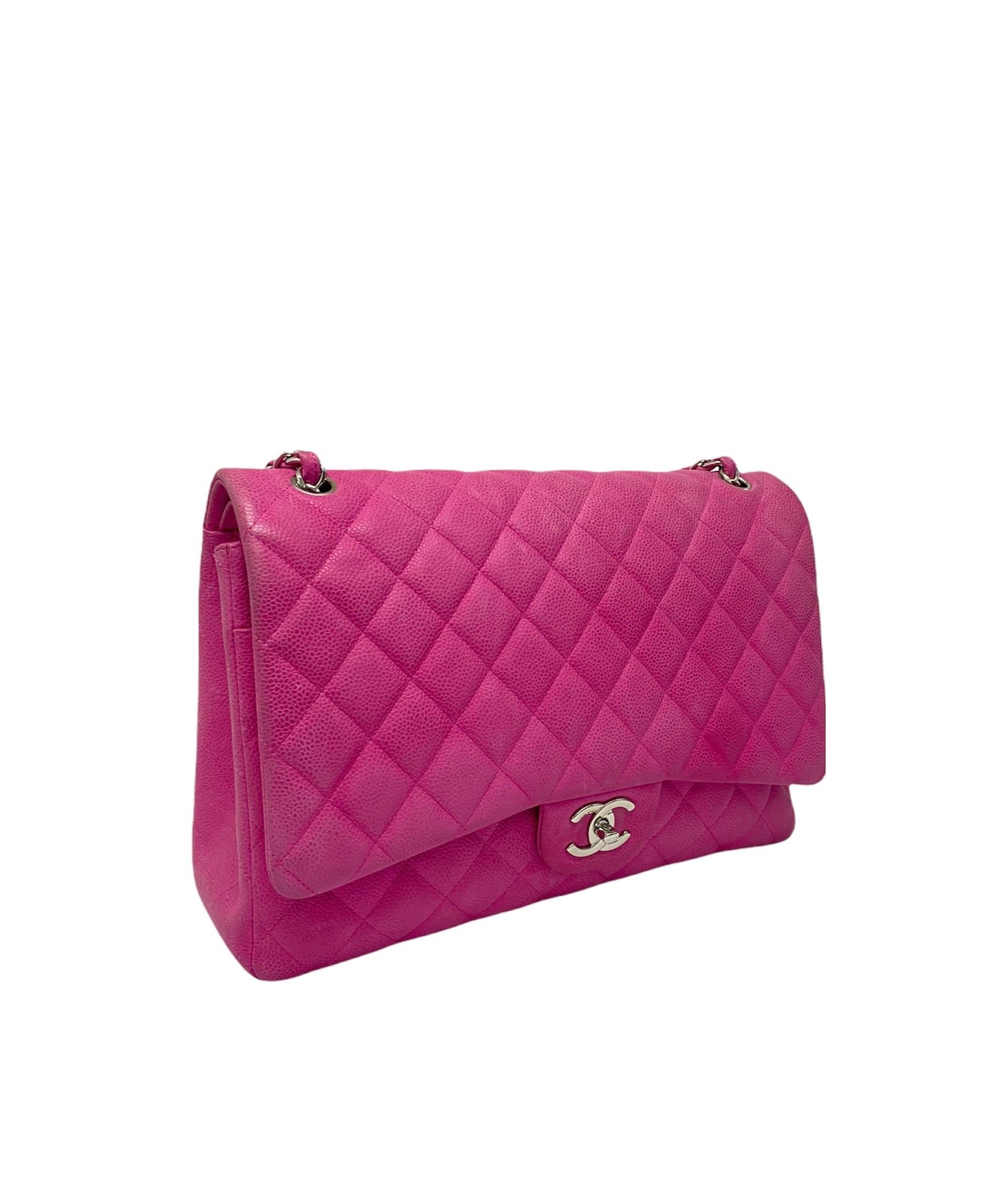 Chanel bag Maxi Jumbo Double Flap edition in fuchsia quilted leather with silver-tone hardware. The bag has two front flaps, a large external one with interlocking CC closure, and another small internal one with button closure. The interior is lined
