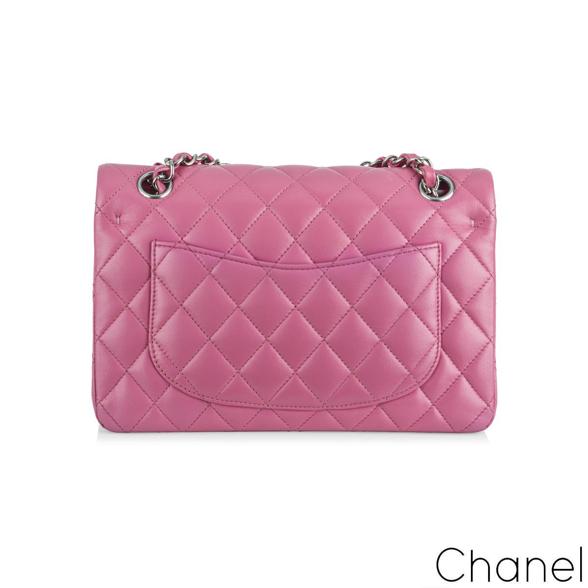 A Timeless Chanel Classic Small Flap Handbag. The exterior of this classic small flap is in vibrant pink lambskin leather with silver tone hardware. It features a front flap with a signature CC turn-lock closure, a half-moon back pocket, and an