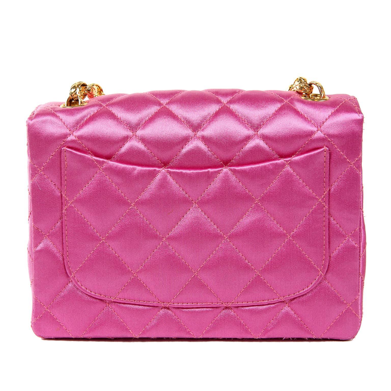Chanel Fuchsia Satin Mini Classic Bag- PRISTINE Condition
  Amazingly preserved from the early 1990’s, it appears never carried.  This classic design is a must have for any collection.   
Vivid hot pink satin is quilted in signature Chanel diamond