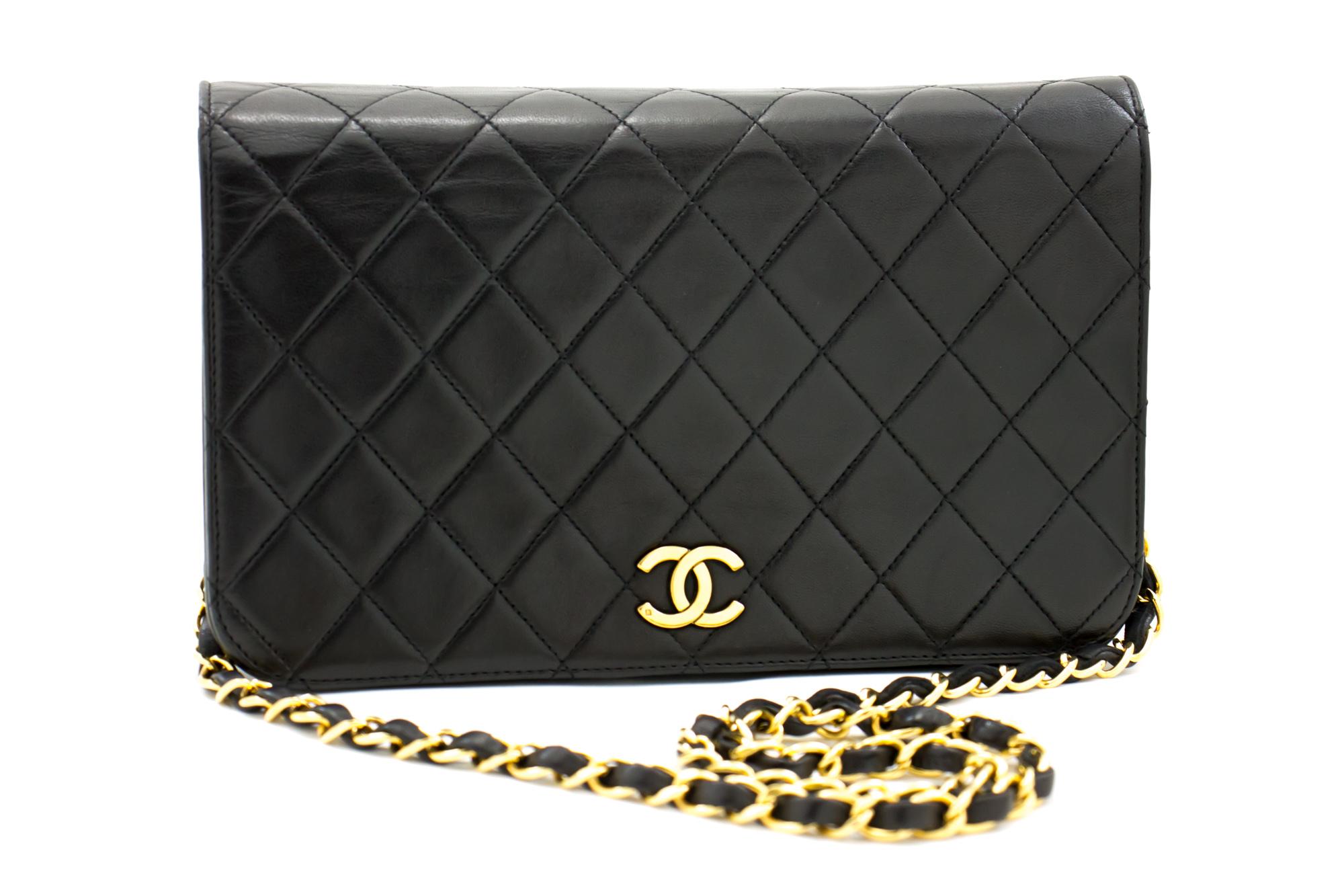 An authentic CHANEL Full Flap Chain Shoulder Bag Clutch Black Quilted made of black Lambskin. The color is Black. The outside material is Leather. The pattern is Solid. This item is Vintage / Classic. The year of manufacture would be