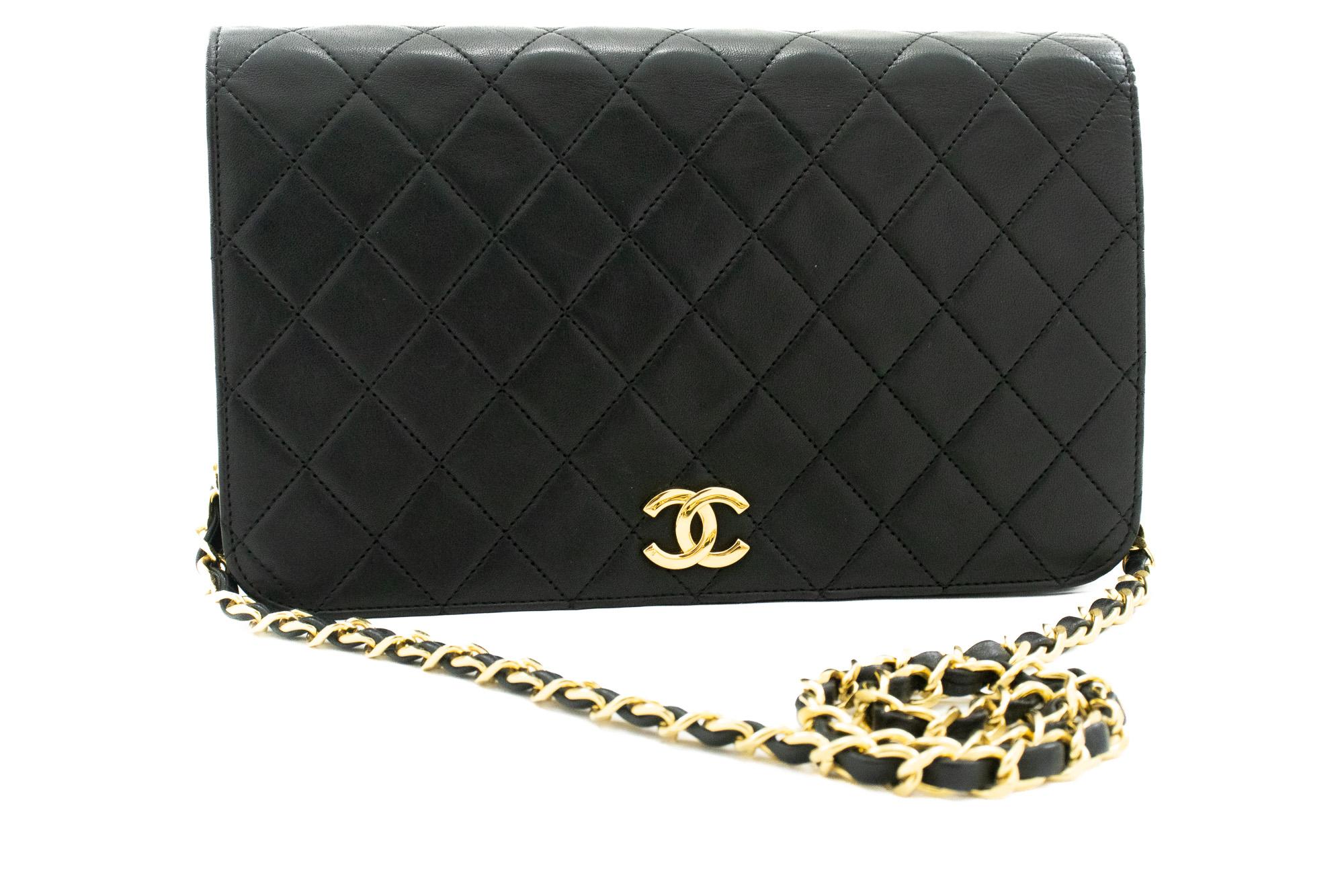 An authentic CHANEL Full Flap Chain Shoulder Bag Clutch Black Quilted made of black Lambskin. The color is Black. The outside material is Leather. The pattern is Solid. This item is Vintage / Classic. The year of manufacture would be