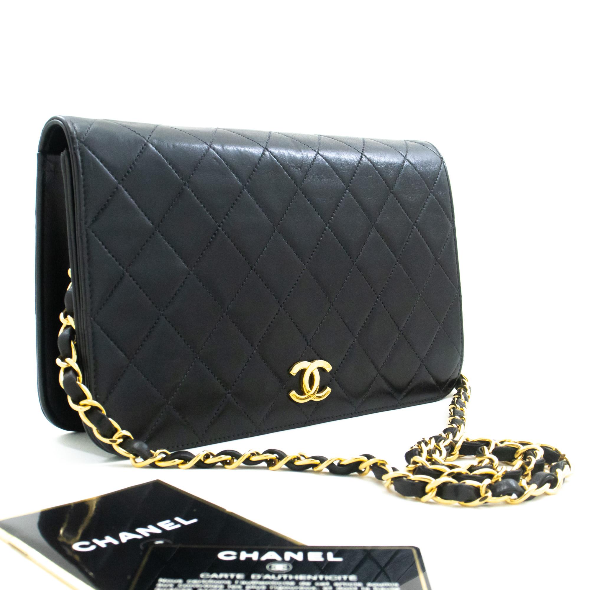 An authentic CHANEL Full Flap Chain Shoulder Bag Clutch Black Quilted made of black Lambskin. The color is Black. The outside material is Leather. The pattern is Solid. This item is Vintage / Classic. The year of manufacture would be 2000-2 0 0 2