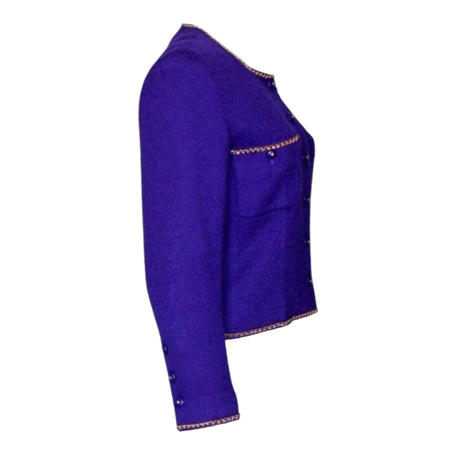 A truly special piece and rare find!
From the FW 1995 collection
This Chanel signature jacket was designed by Karl Lagerfeld
Beautiful purple tweed fabric by Maison Lesage
Chain trimming details in front
Two front pockets
Fitted style
CC logo