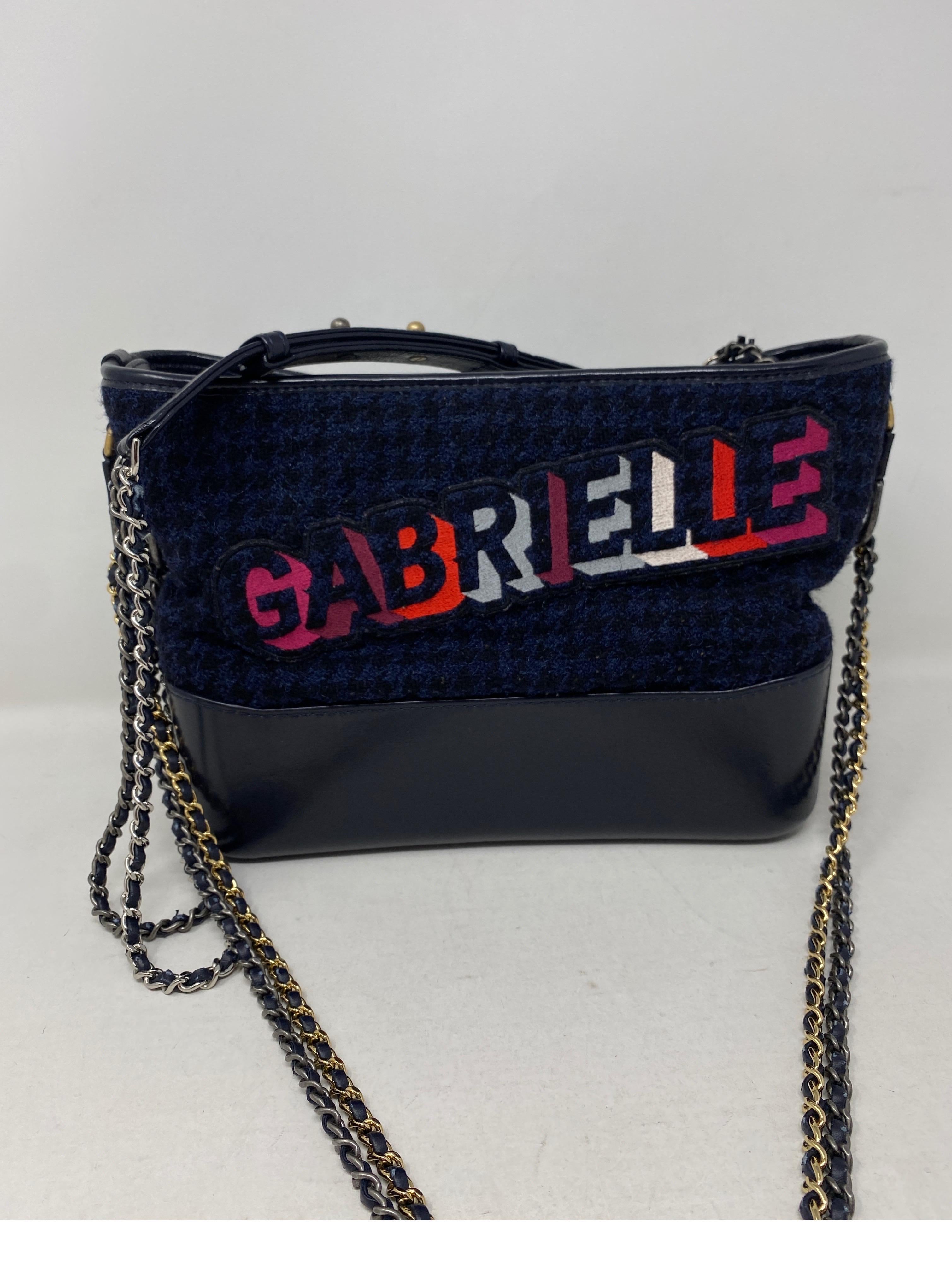 Chanel Gabrielle Crossbody Bag. Gabrielle letters over navy tweed fabric. Leather trim and two tone chains. Mint like new condition. Rare and limited bag. Unique collector's piece. Don't miss out on this one. Guaranteed authentic. 