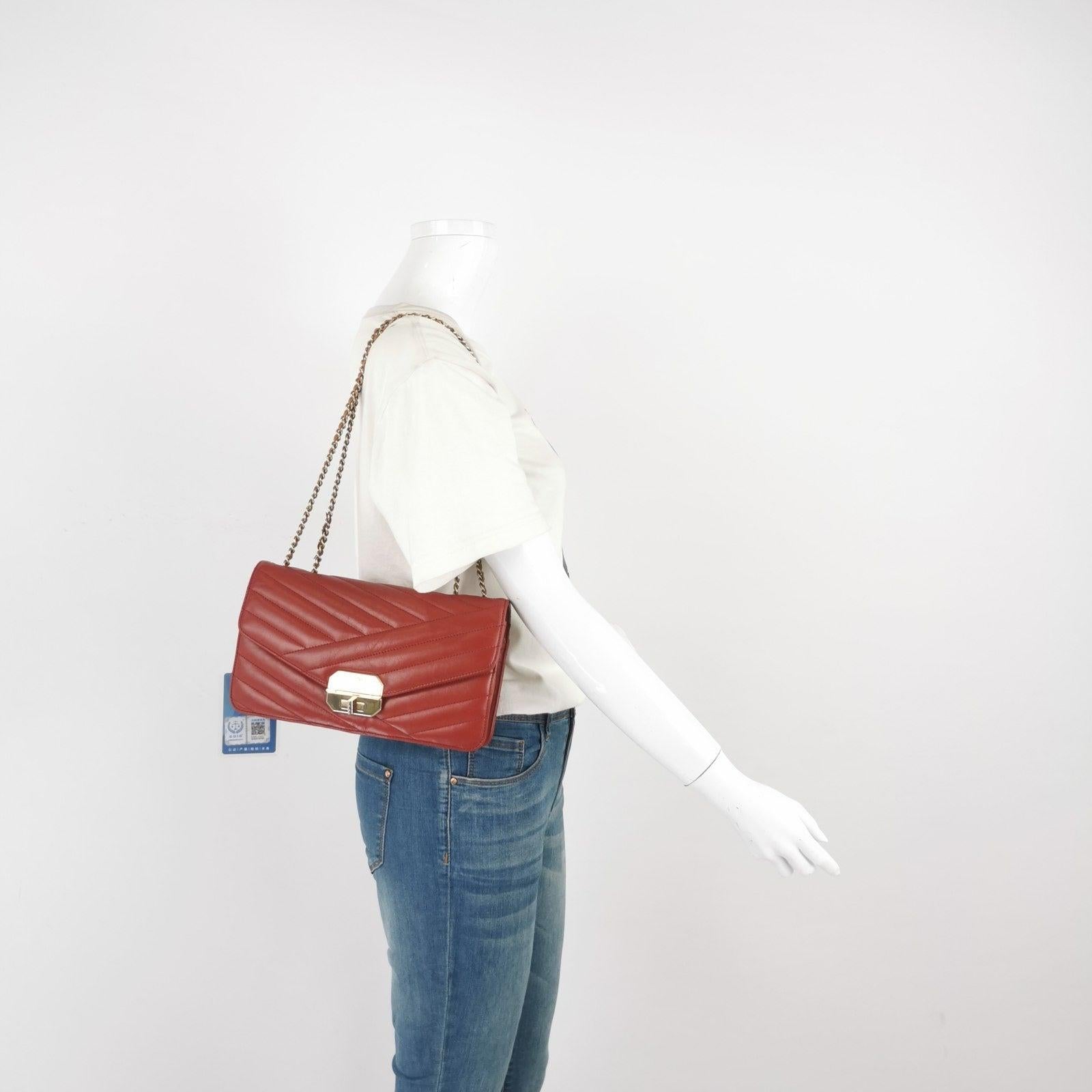 Chanel Gabrielle Flap Bag 2011-2012 Chevron Leather Medium Red Shoulder Bag These are professional photos of the actual bag offered by Luxbags. Introducing the Gabrielle shoulder bag, a standout piece from Chanel's 2012 Cruise collection. Made from