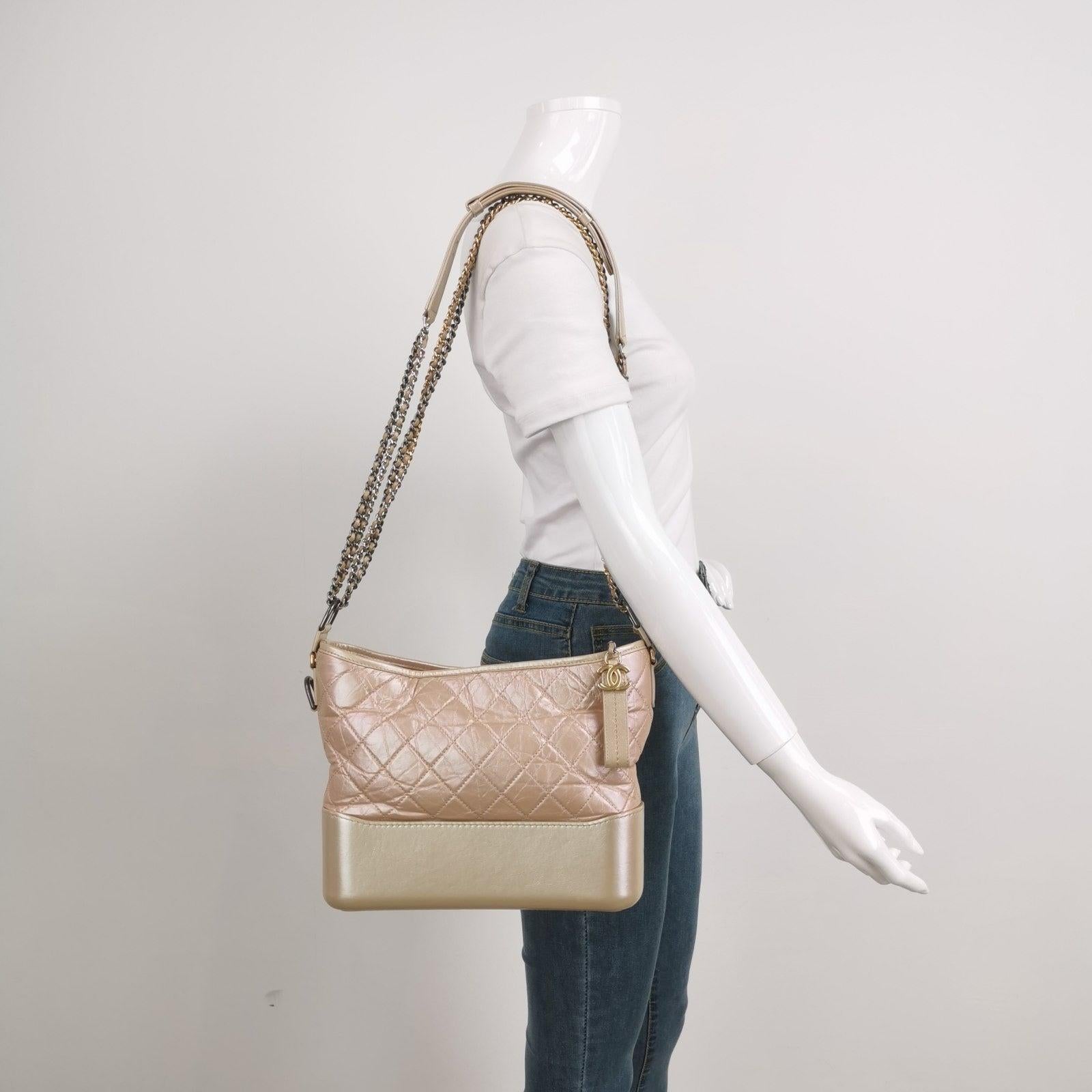 Chanel Gabrielle Hobo 2019 Iridescent Pink Leather Medium Crossbody Bag These are professional photos of the actual bag offered by Luxbags. Designed by Lagerfeld, the form of the Gabrielle line of bags was inspired by vintage binocular cases and