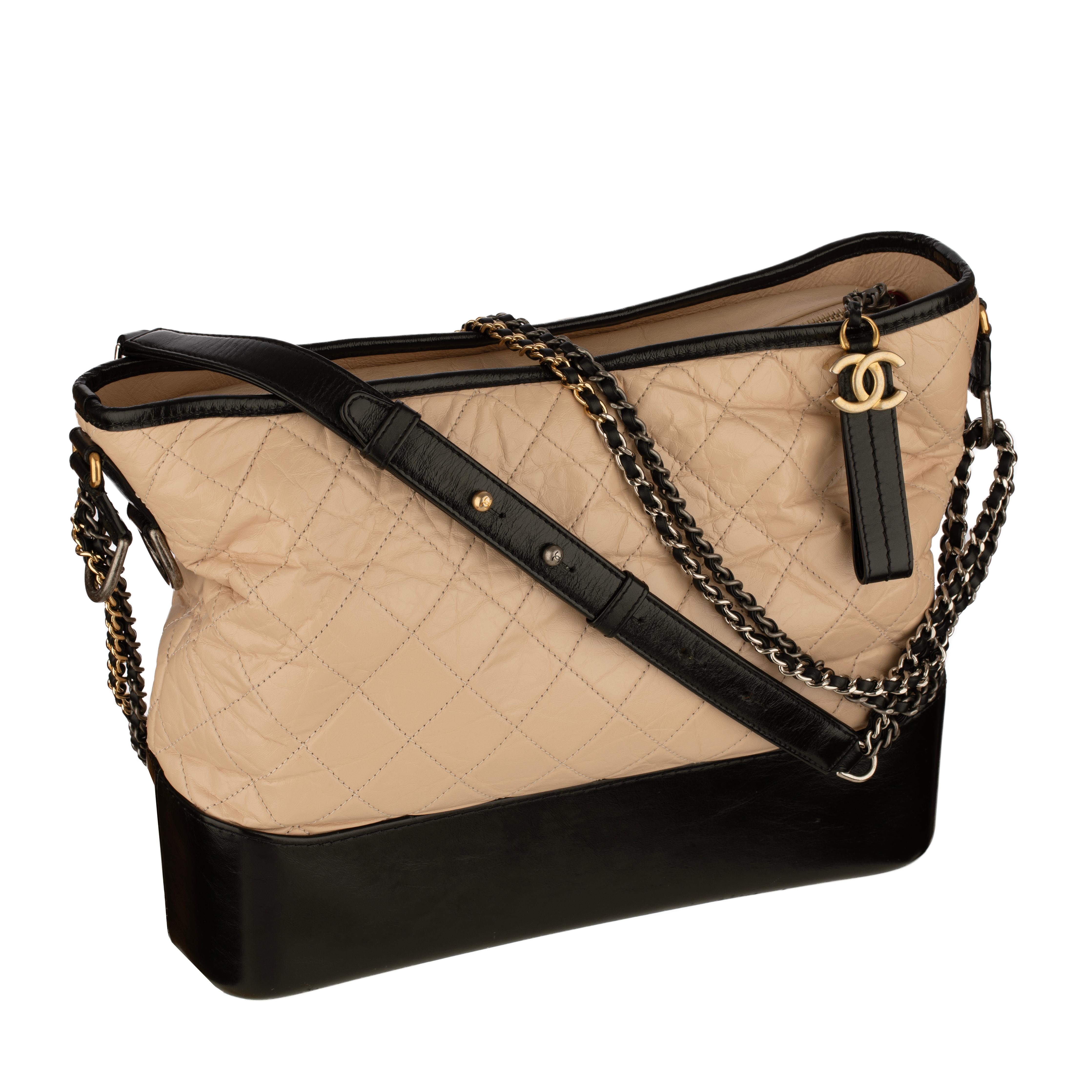 Elevate your everyday style with this authentic Chanel Gabrielle Large Hobo Bag crafted in quilted beige aged calfskin and smooth black calfskin leather. Finished with Chanel’s signature mixed metal hardware and a convertible leather-threaded chain