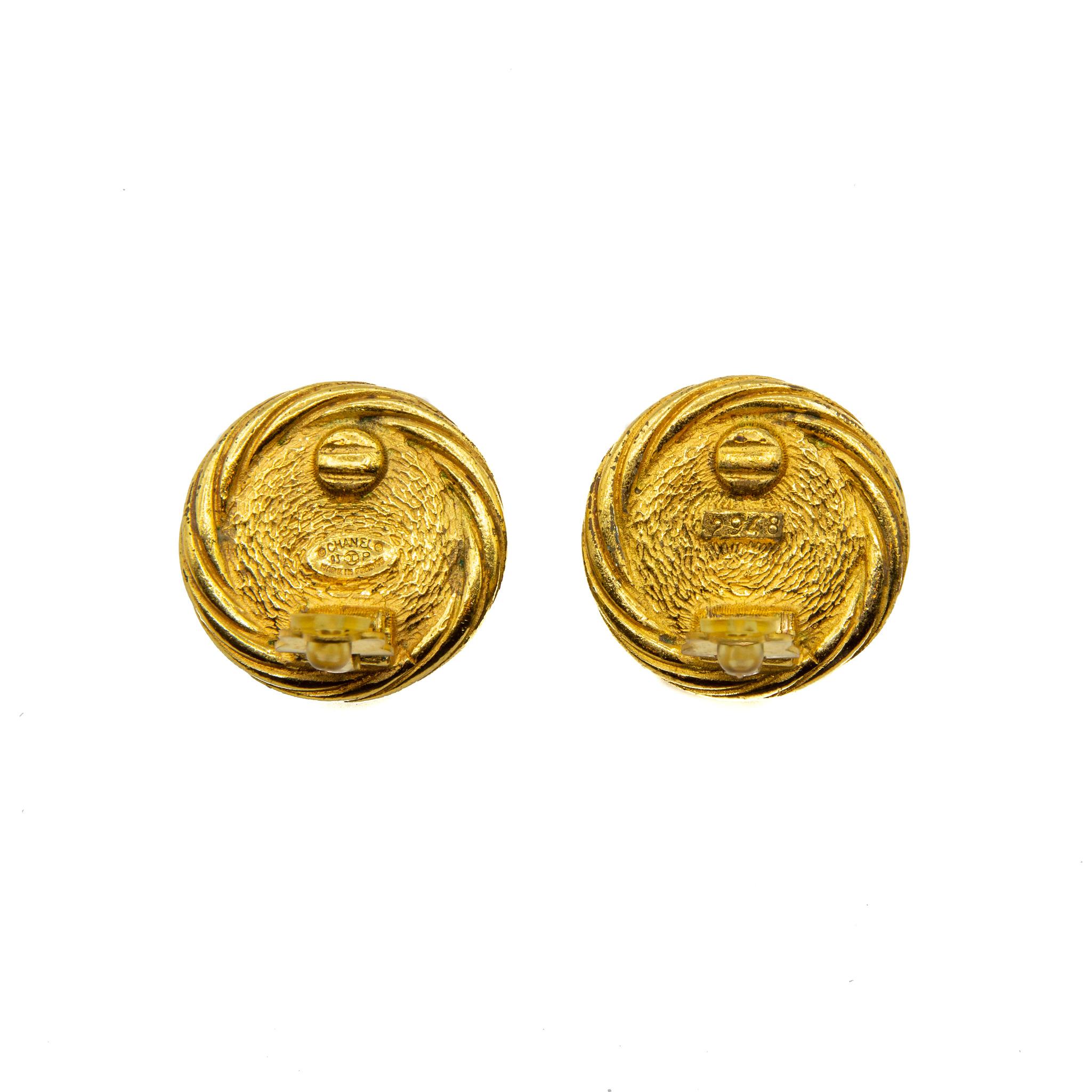 Chanel Gilt and Faux Pearl Spring 1993 Clip-on Earrings. Featuring twisted design in gold-coloured gilt encapsulating the faux pearl and the house logo stamped below. This piece features the Chanel authenticity plaque. Provenience France. 