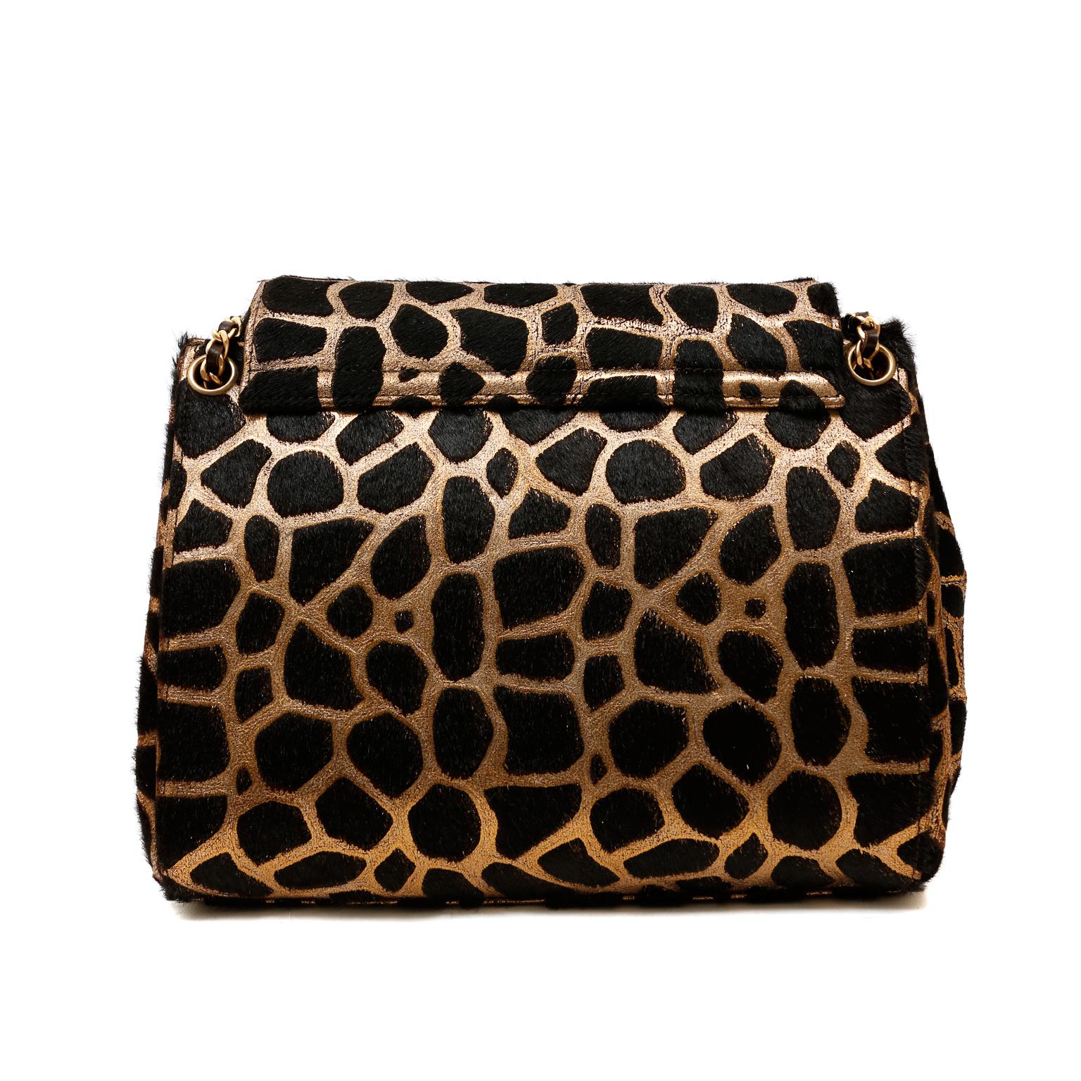 This authentic Chanel Giraffe Calf Hair Flap Bag is in pristine condition.  The limited-edition piece is from a runway show in Paris.  We also have the matching shoes and skirt available in our boutique.  This listing is for the bag only.  
Black