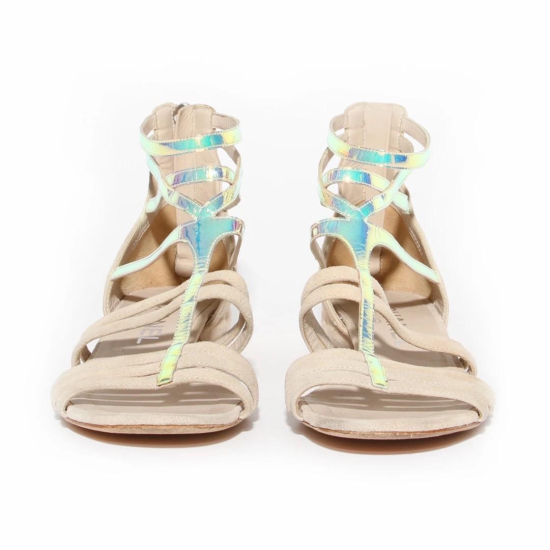 Chanel by Karl Lagerfeld Gladiator Sandal 
Spring / Summer 2012 Ready-to-Wear Collection 
Made in Italy 
Light tan suede 
Iridescent foil details on front of sandal 
Zipper on back of sandal 
Suede leather zipper pull with silver interlocked CC